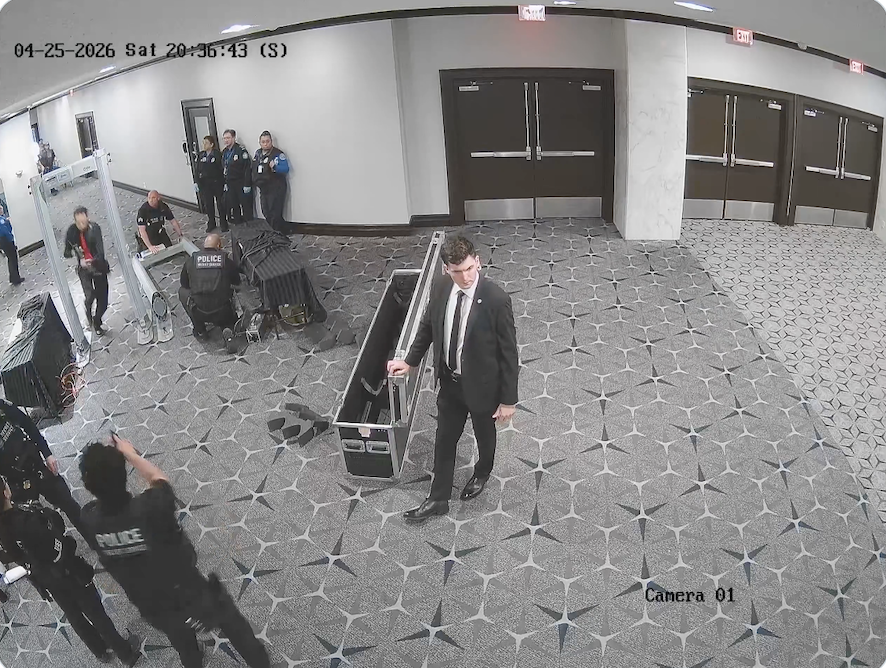 Frame showing gunman charging into dinner