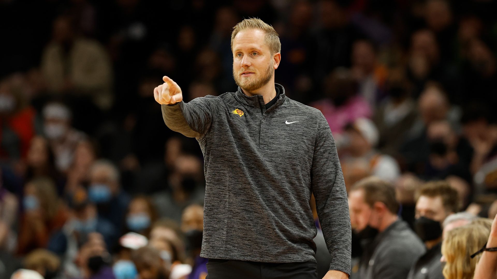 Basketball coach Kevin Young points during a game.