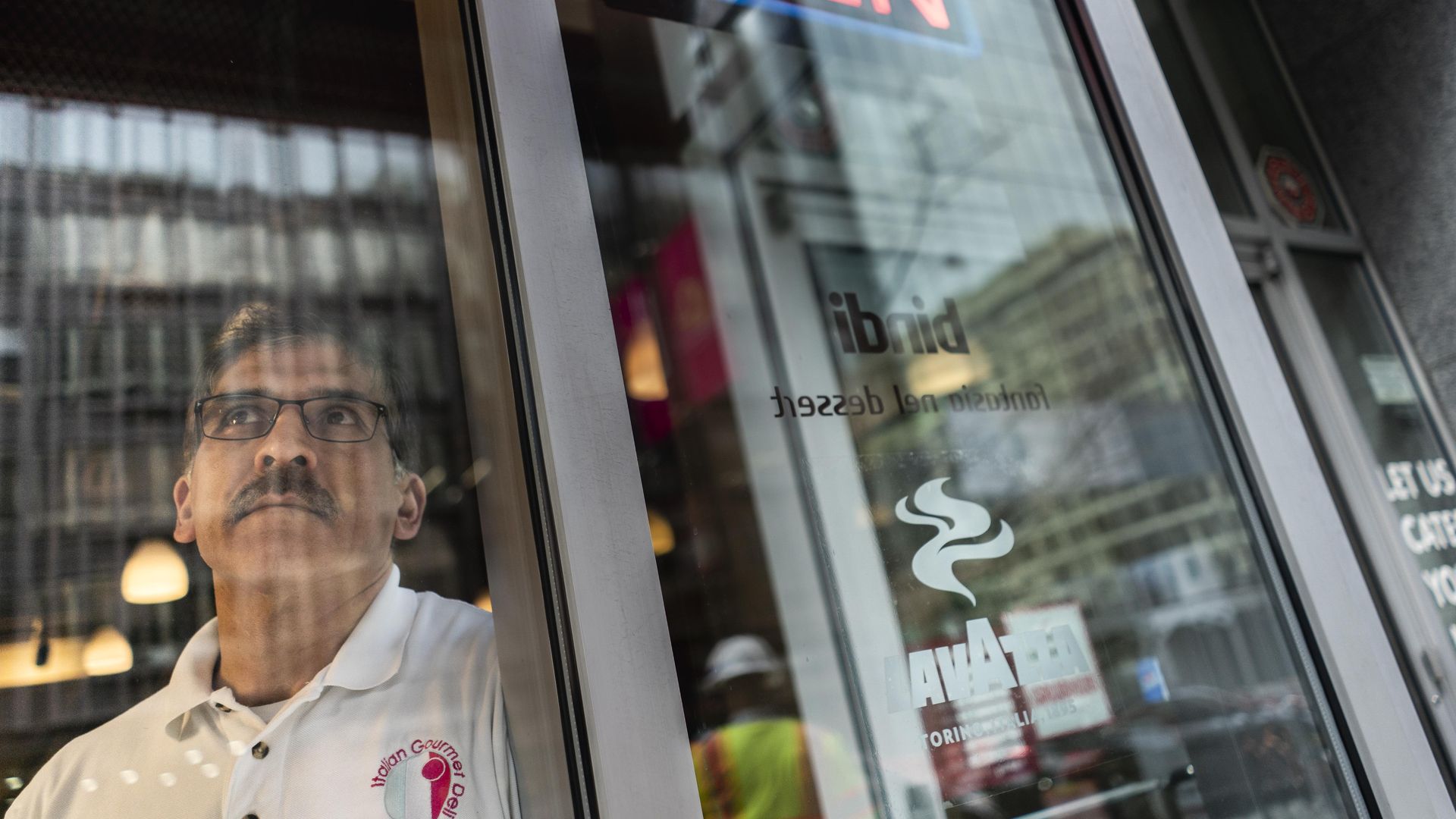 small business owner looks out the window