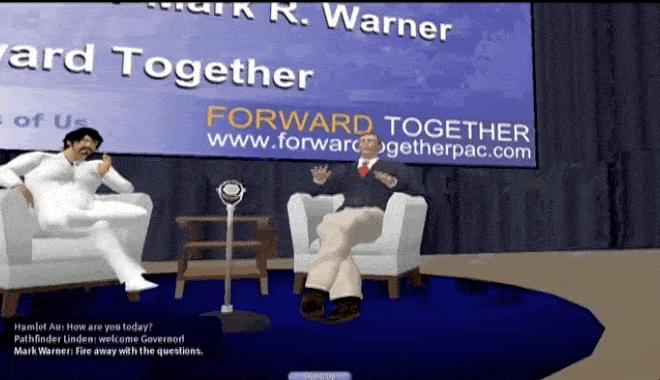 A gif of a virtual avatar of Mark Warner, sitting down, while the camera zooms in on him