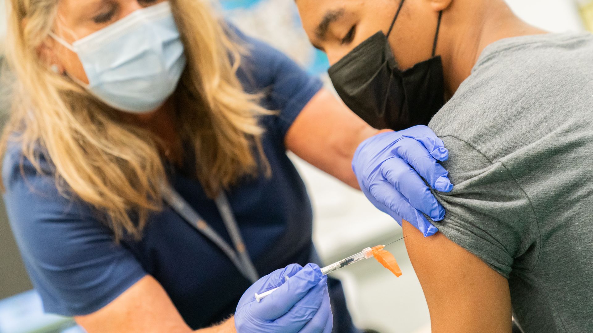 A healthcare worker administers a dose of the covid vaccine