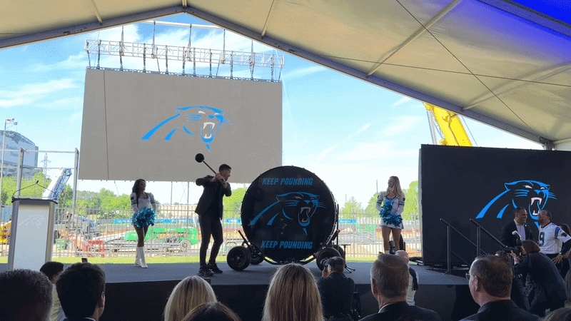 Panthers head coach Dave Canales banging the team's Keep Pounding drum. 