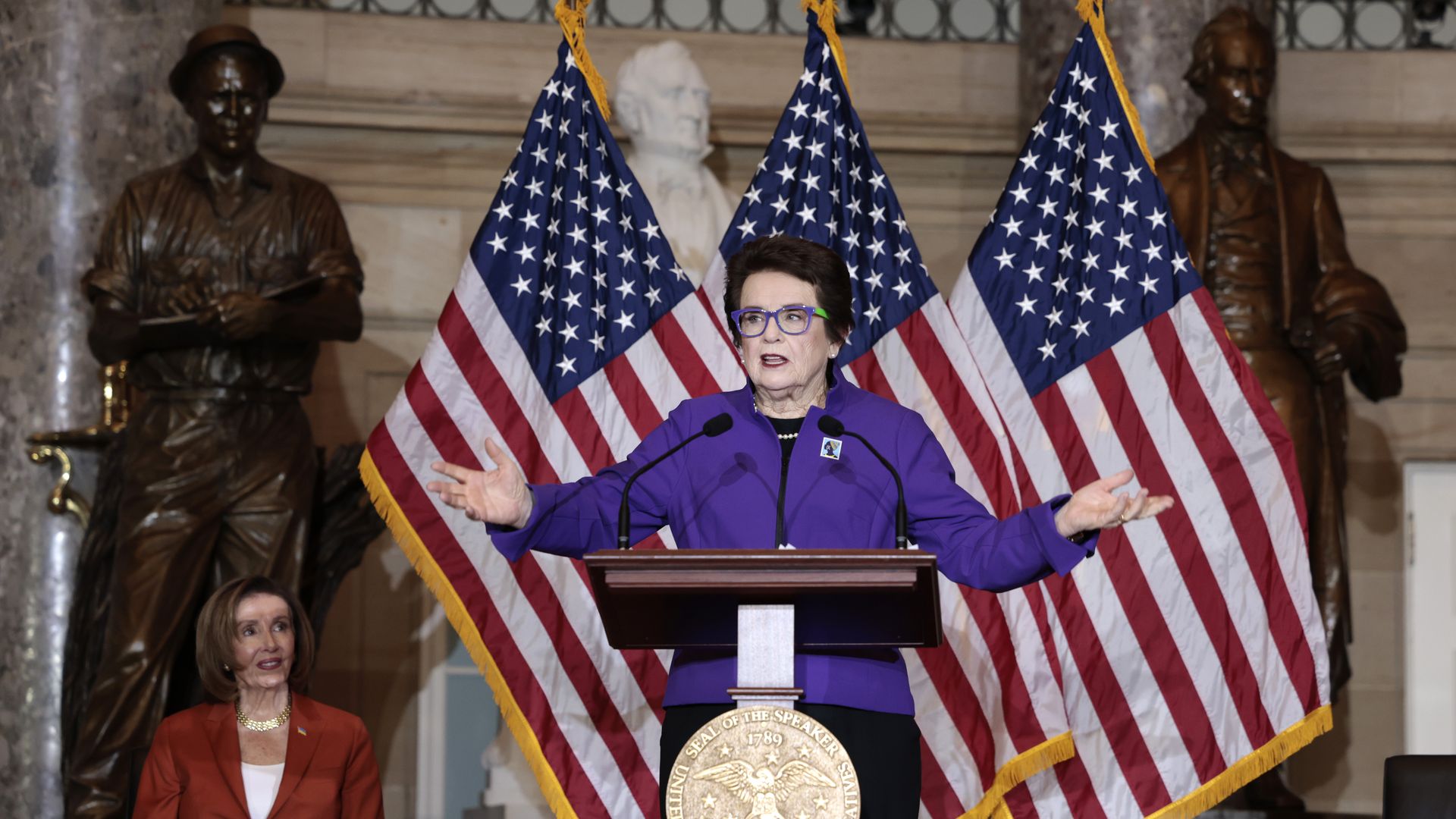 House Speaker Nancy Pelosi is seen looking on as tennis star Billie Jean King speaks as part of Women's History Month.