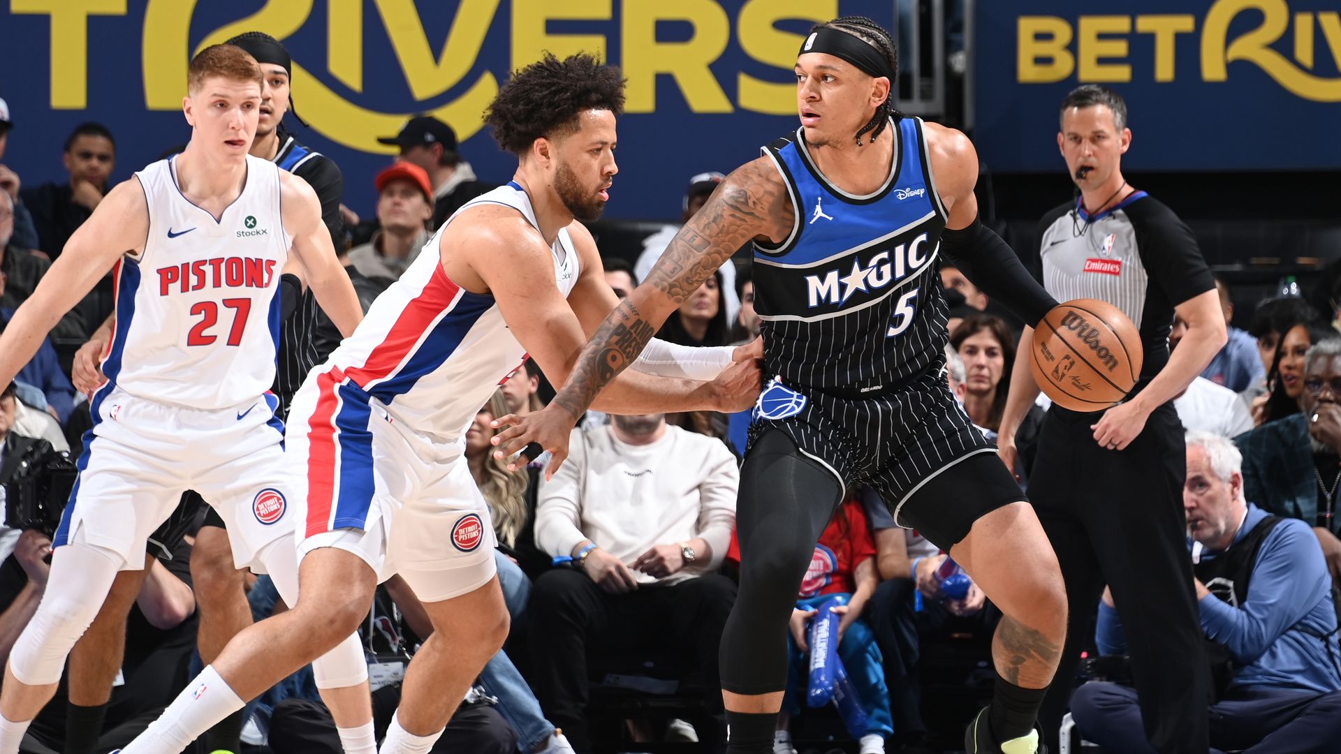 Cade Cunningham defends Orlando's Paolo Banchero. 