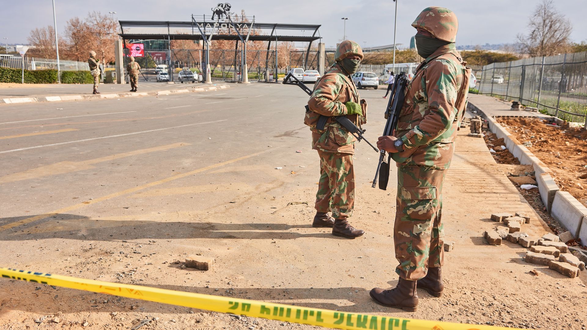 Armed soldiers from the South African National Defence Force (SANDF) patrol at the gates of Maponya Mall following rioting in the Soweto district of Johannesburg, South Africa.