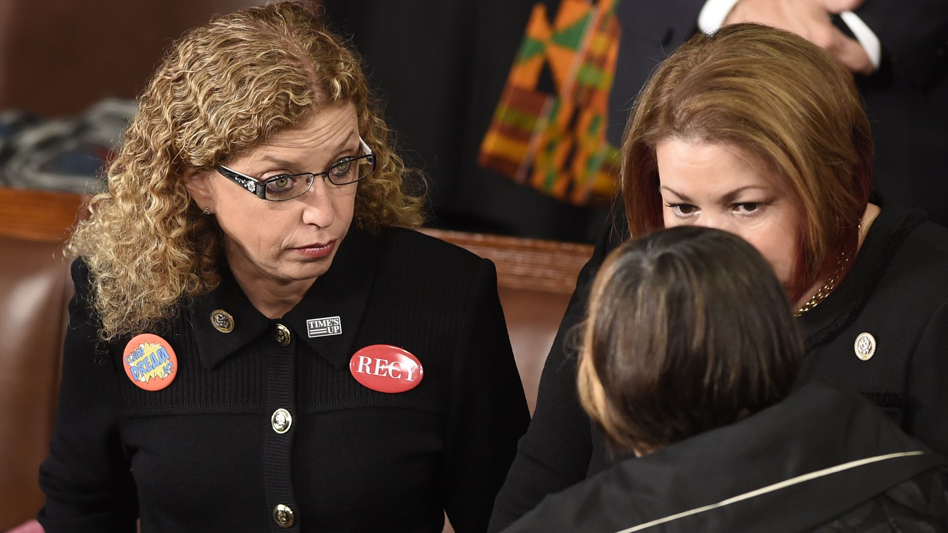 Rep. Debbie Wasserman Schultz in a black top and glasses with red pins