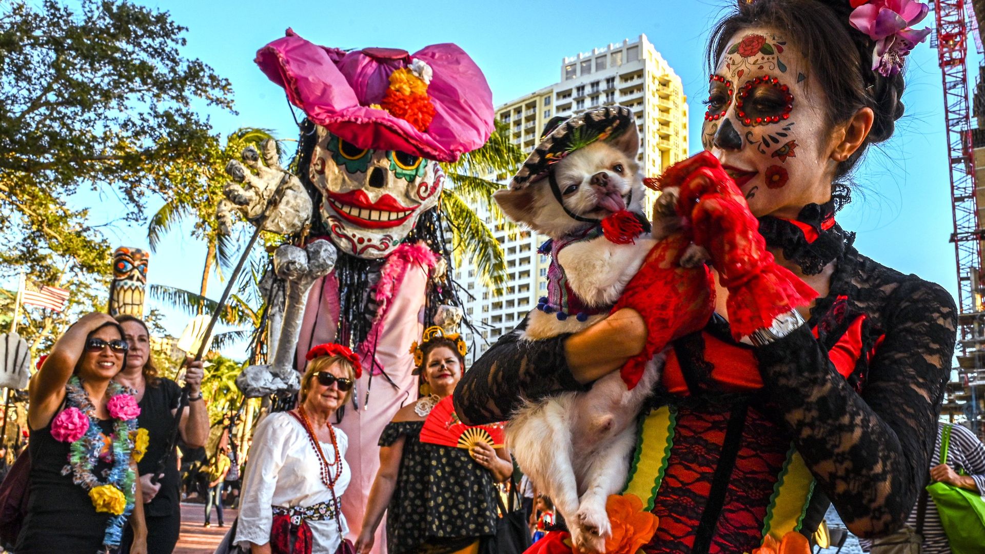 A group of people dressed in skeletons and flowers to celebrate Day of the Dead 