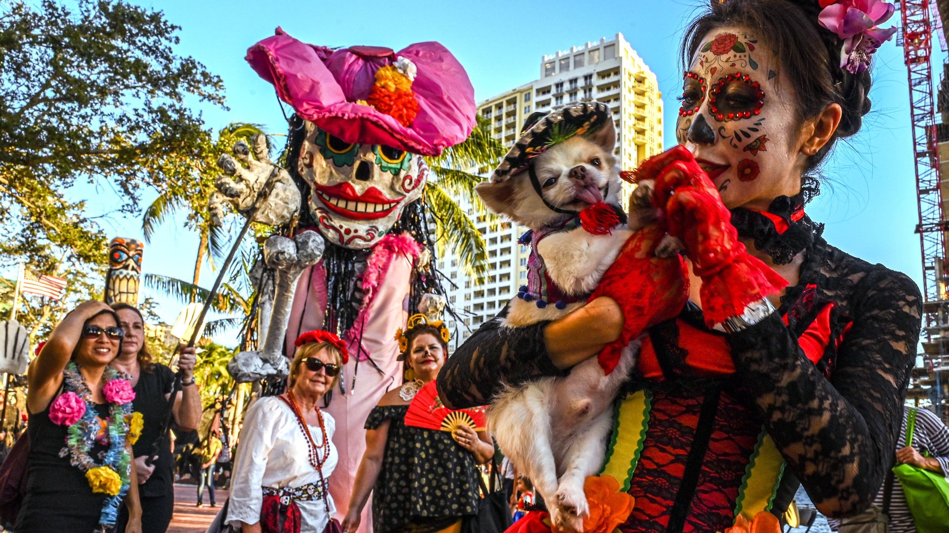 A group of people dressed in skeletons and flowers to celebrate Day of the Dead