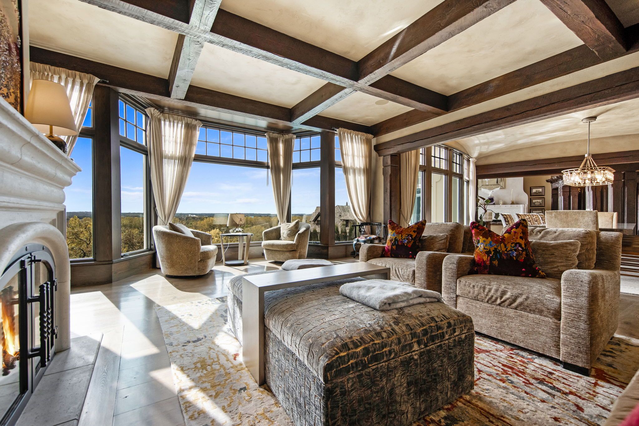 A family room with river valley views out the window.