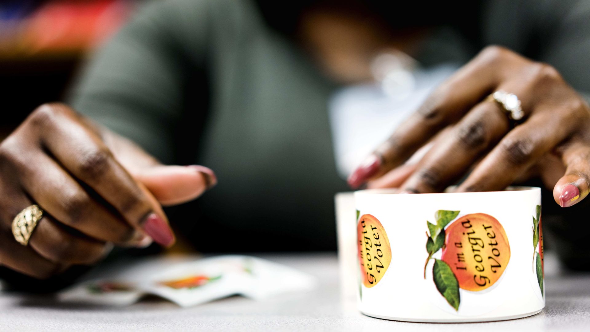 Woman touches Georgia I voted stickers.