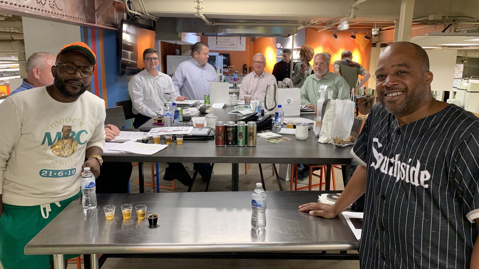 Photo of two men posing for camera while doing a presentation