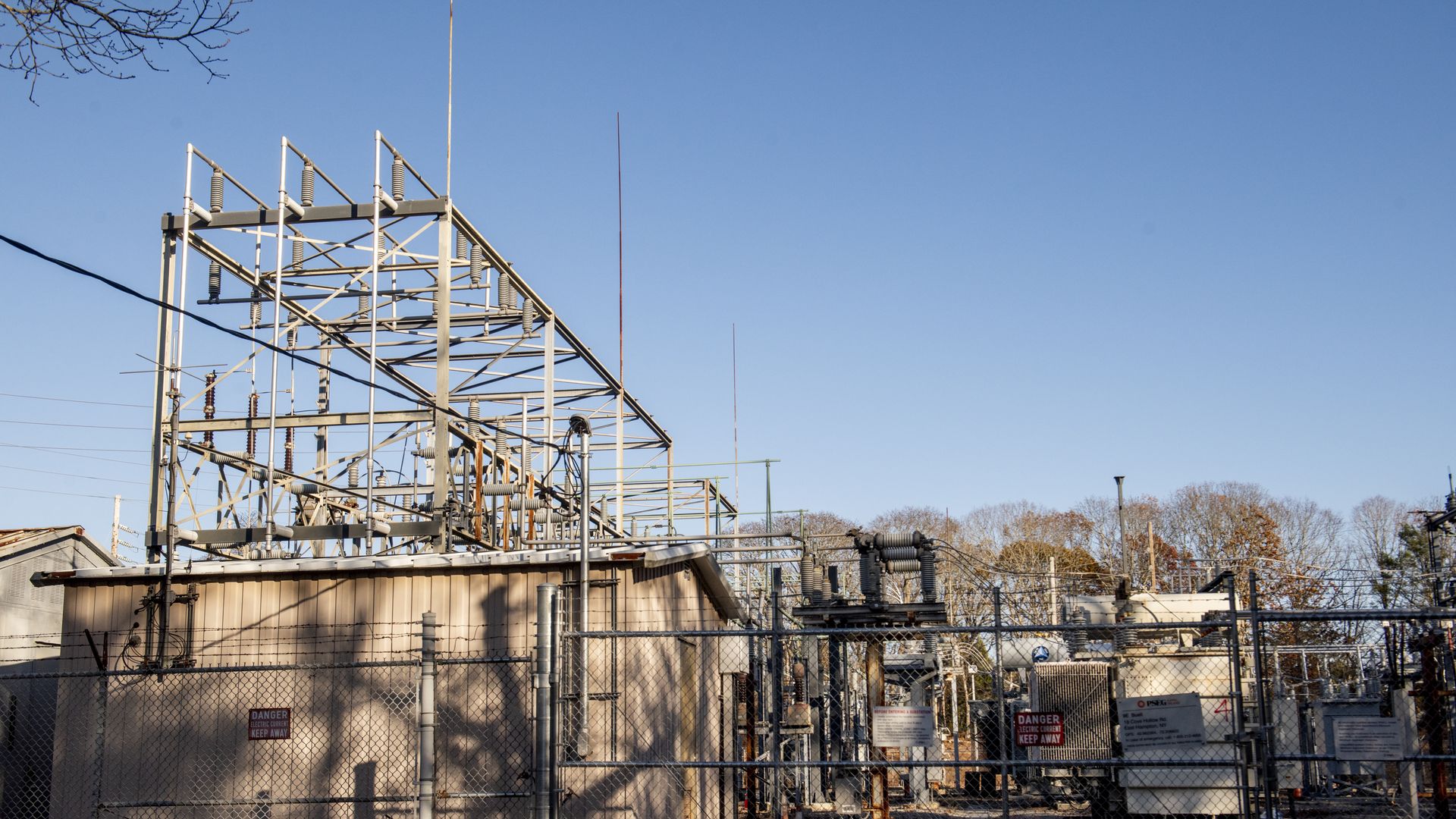 A photo of a substation. The sky is blue in the background.