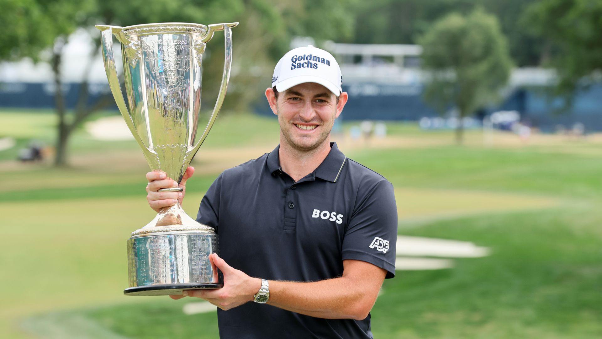 patrick cantlay posing with trophy