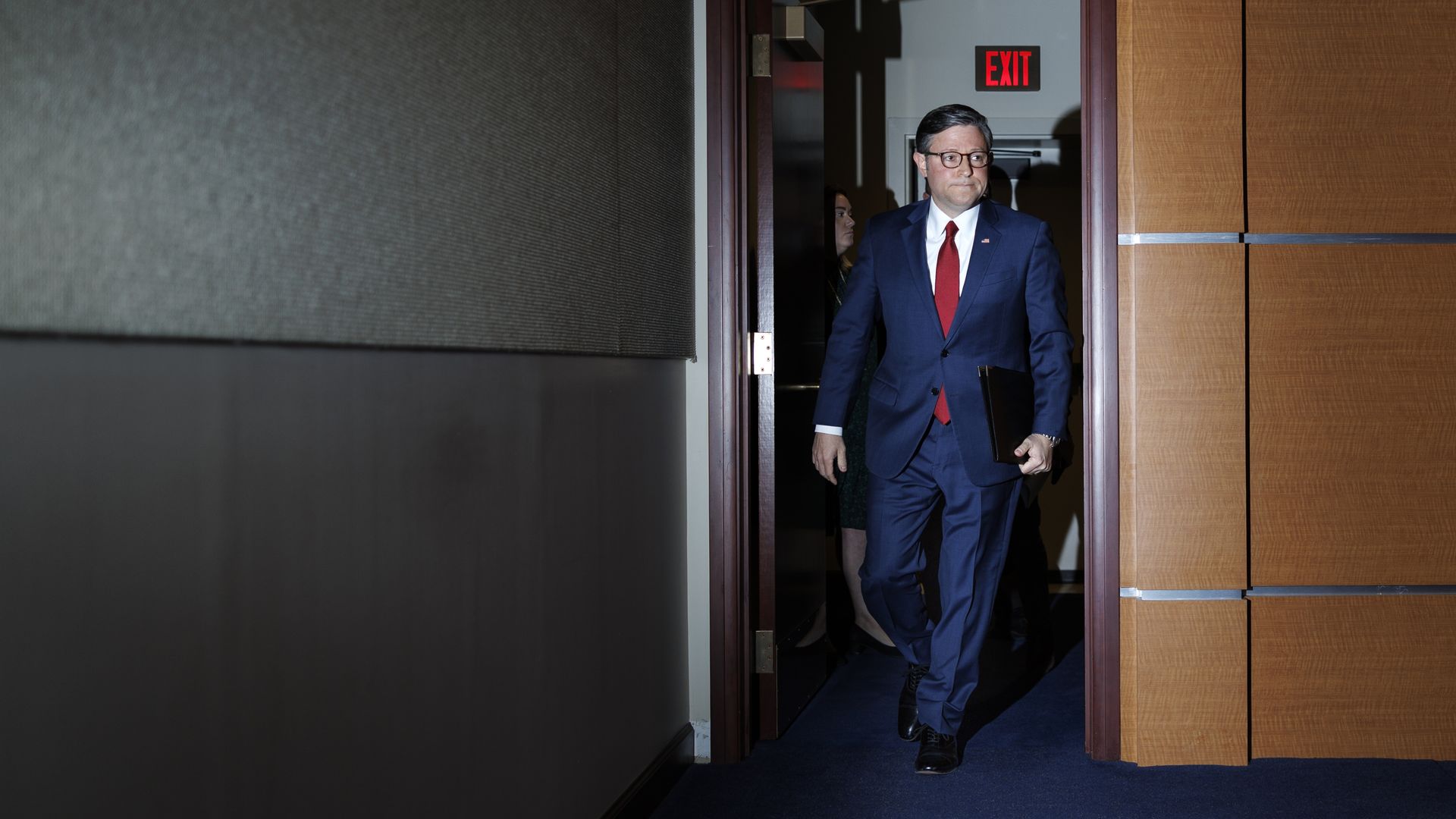 Speaker Johnson walks to the podium for a press conference 