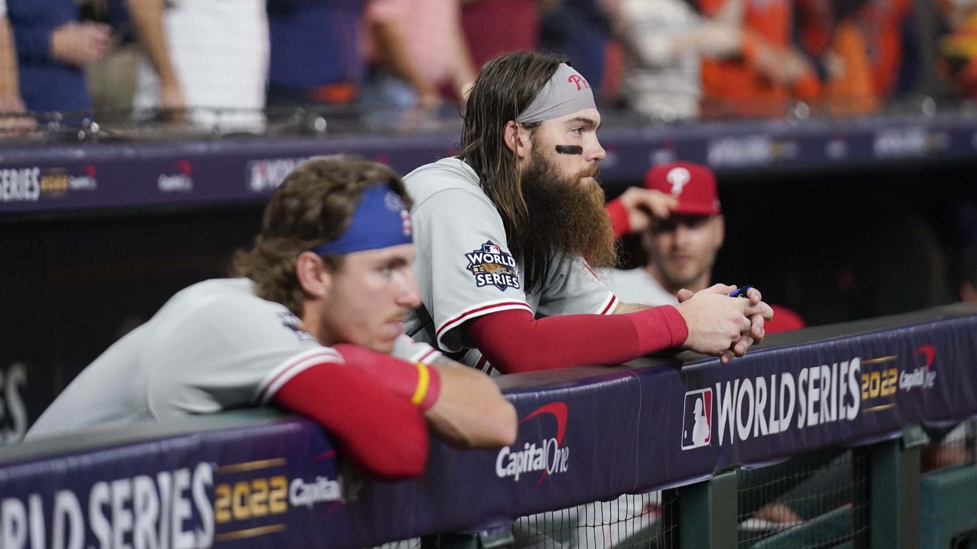 The Philadelphia Phillies watch the Houston Astros celebrate their 4-1 World Series from the dugout