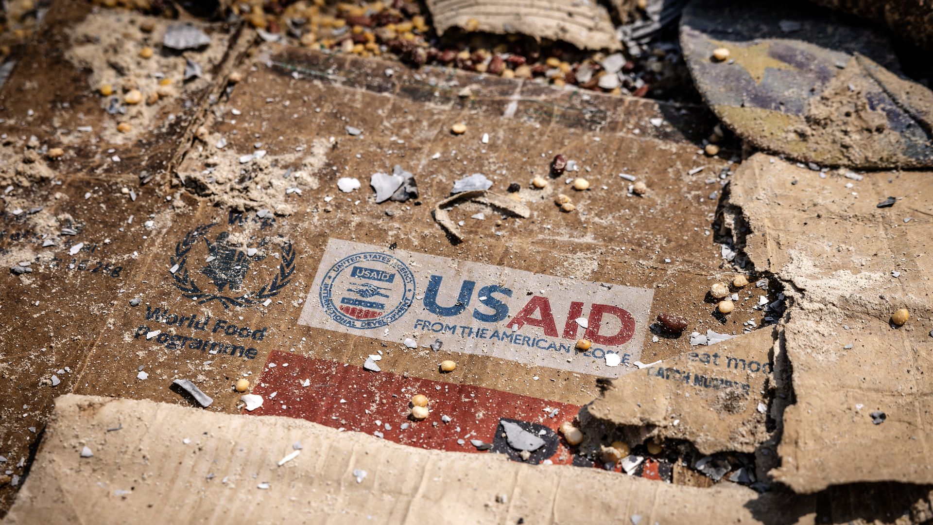   A USAID logo is visible on a box amid the scattered remains of boxes and materials left behind by looters after widespread vandalism and looting following clashes at the World Food Programme (WFP) warehouse in Bukavu on February 21, 2025. 