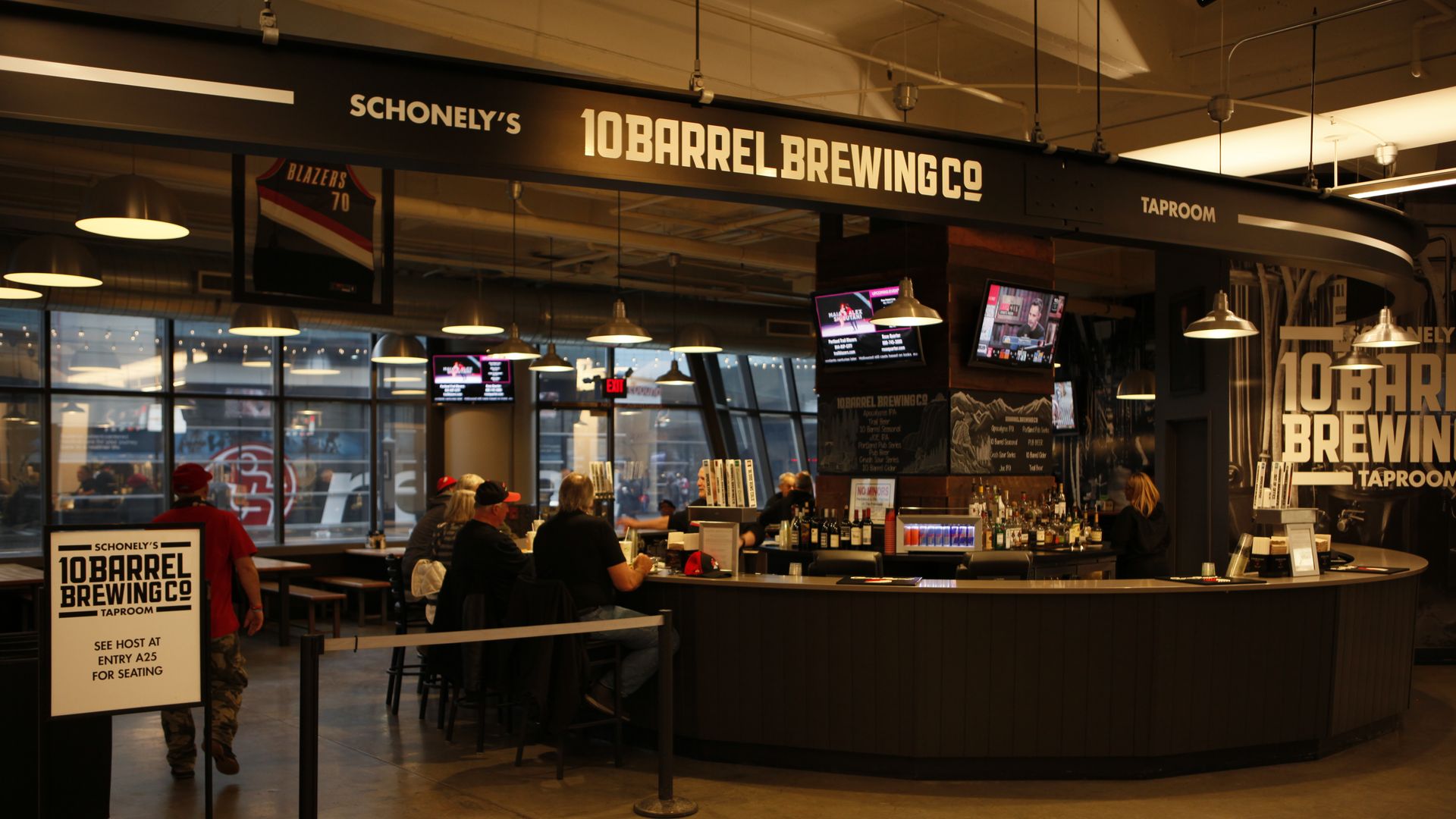 The interior of a bar with a sign reading 10 barrel brewing above it.