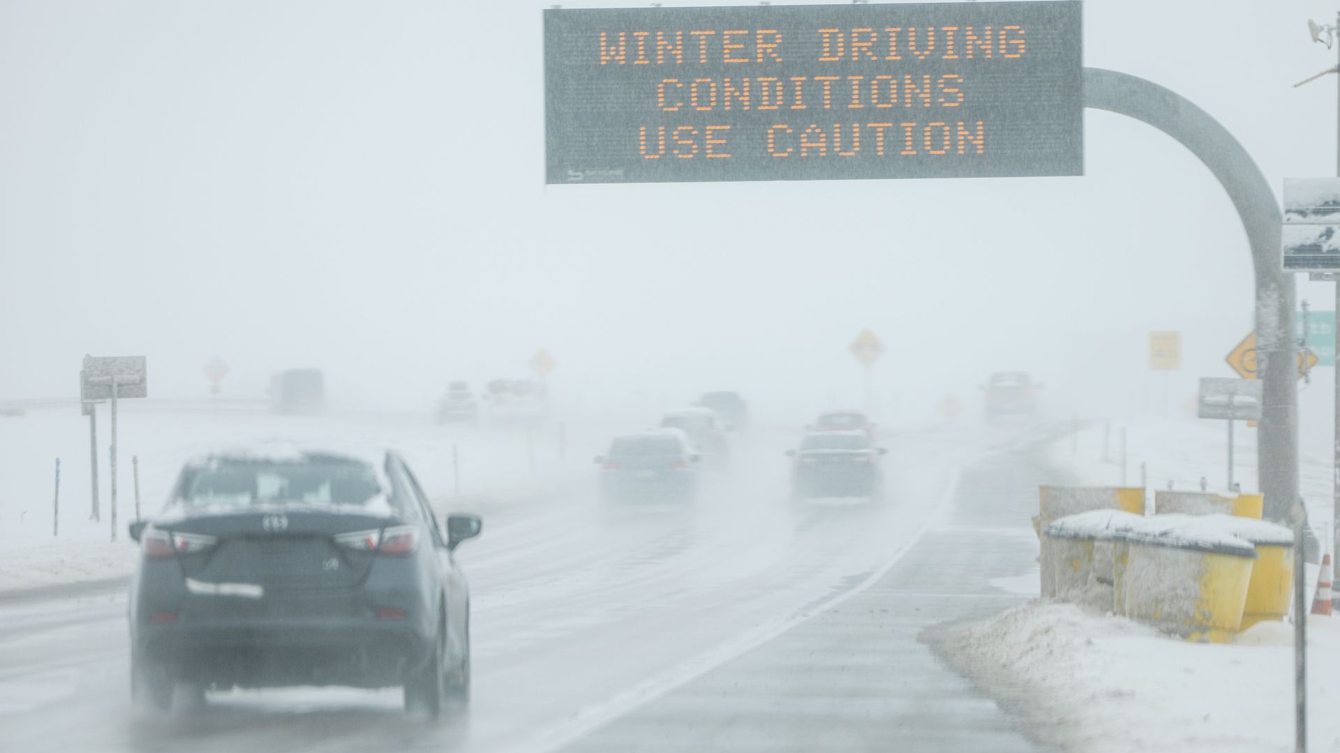 Drivers make their way along slick and snowy roads on November 26, 2019 in Denver, Colorado. 