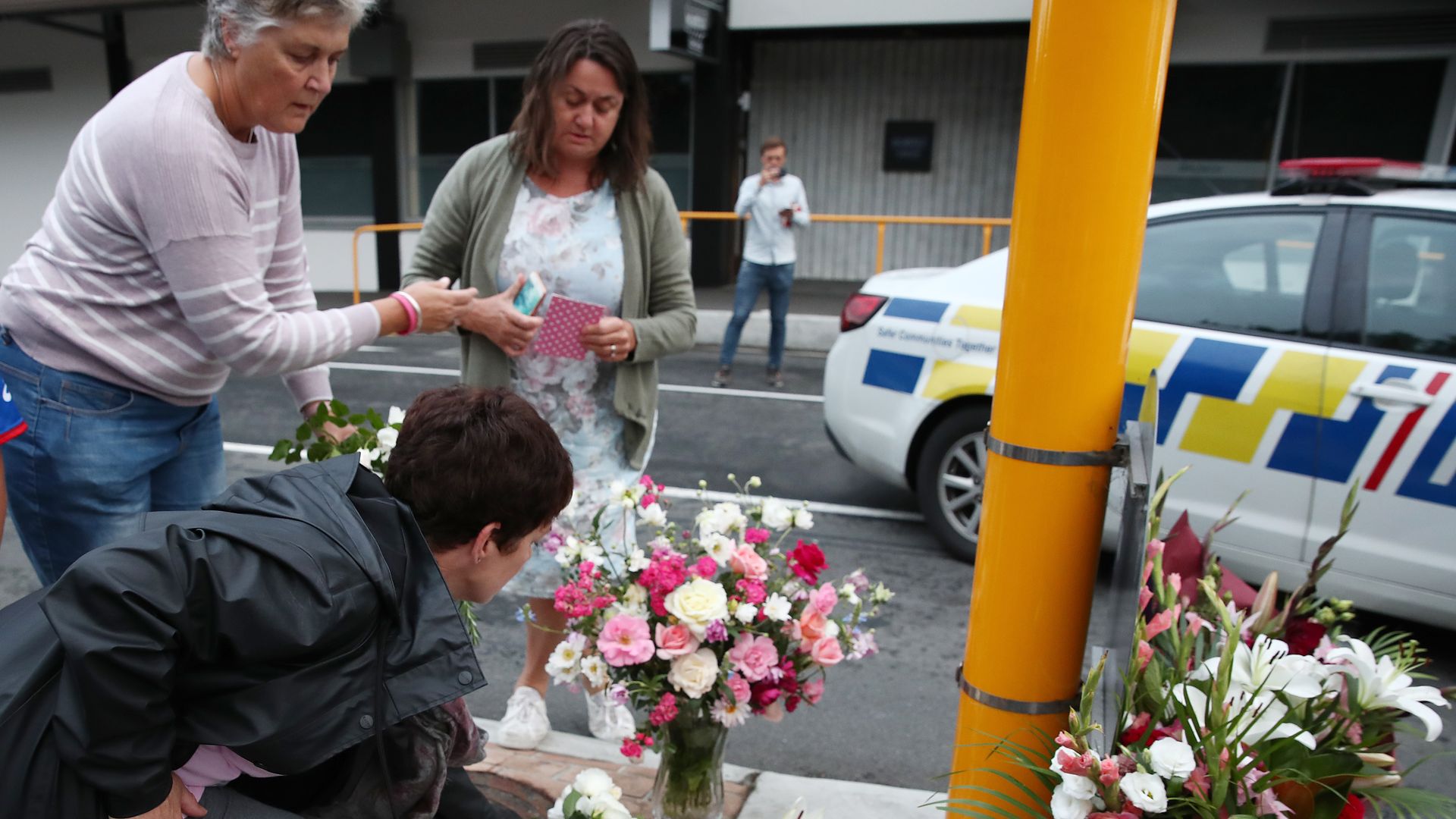 People dropping off flowers in solidarity with mosques in New Zealand.