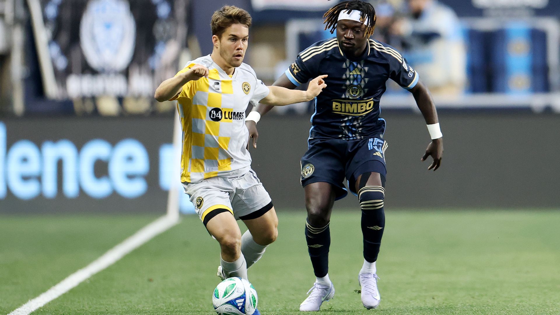 CHESTER, PENNSYLVANIA - MAY 21: Robbie Mertz #14 of Pittsburgh Riverhounds SC controls the ball against Olivier Mbaizo #15 of Philadelphia Union during a 2025 U.S. Open Cup Round Of 16 game at Subaru Park on May 21, 2025 in Chester, Pennsylvania. (Photo by Emilee Chinn/USSF/Getty Images)