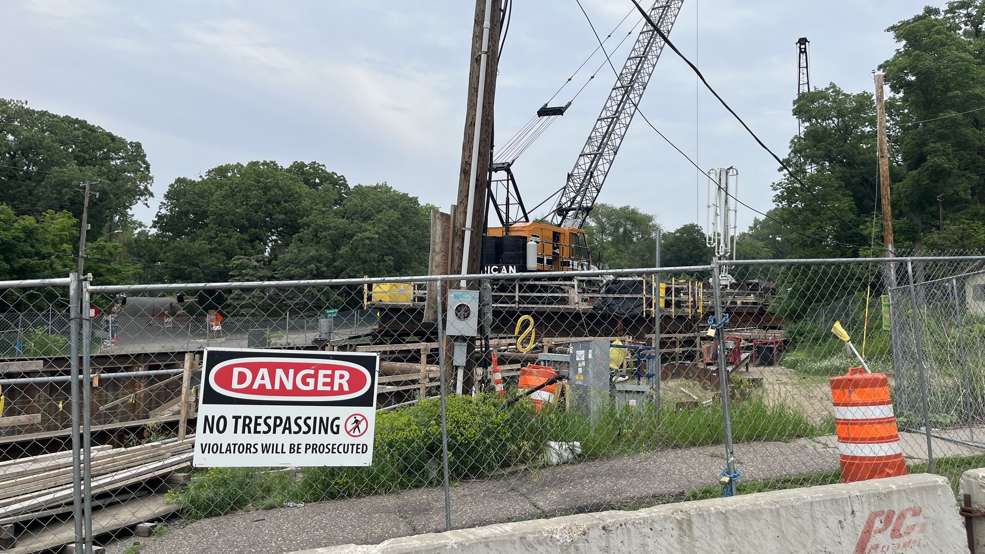 A fence with construction equipment behind it