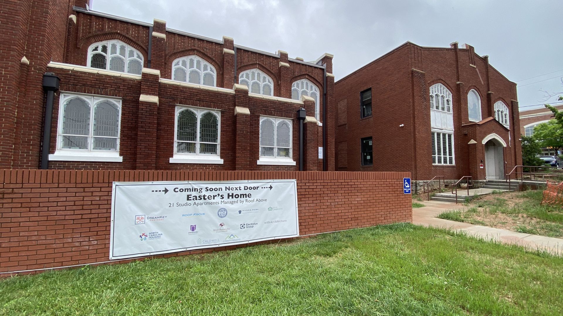 Caldwell Presbyterian Church and Easter's Home to the right. Both are brick buildings. 