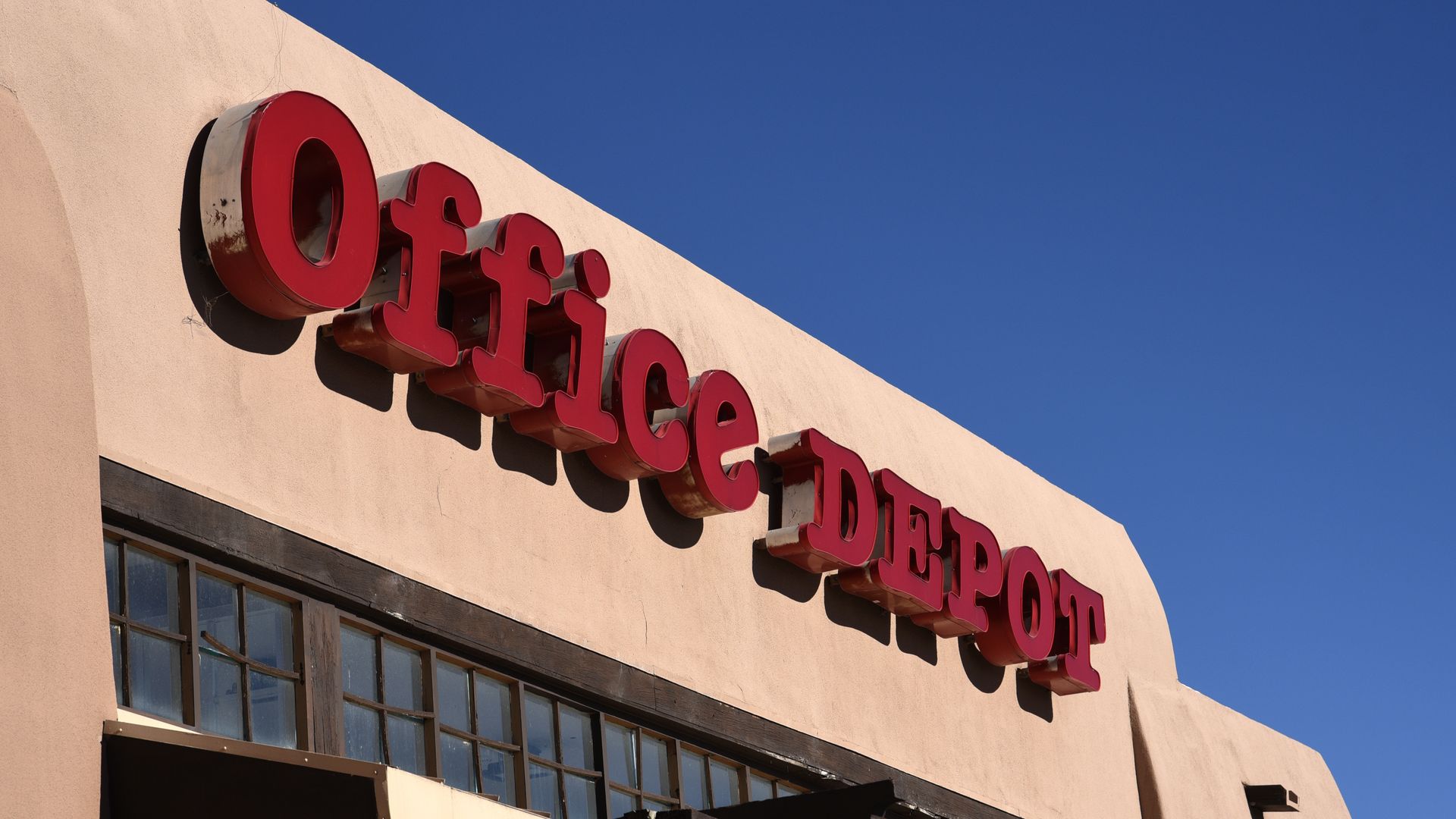 A store front with Office Depot spelled out in big red letters above the entrance.