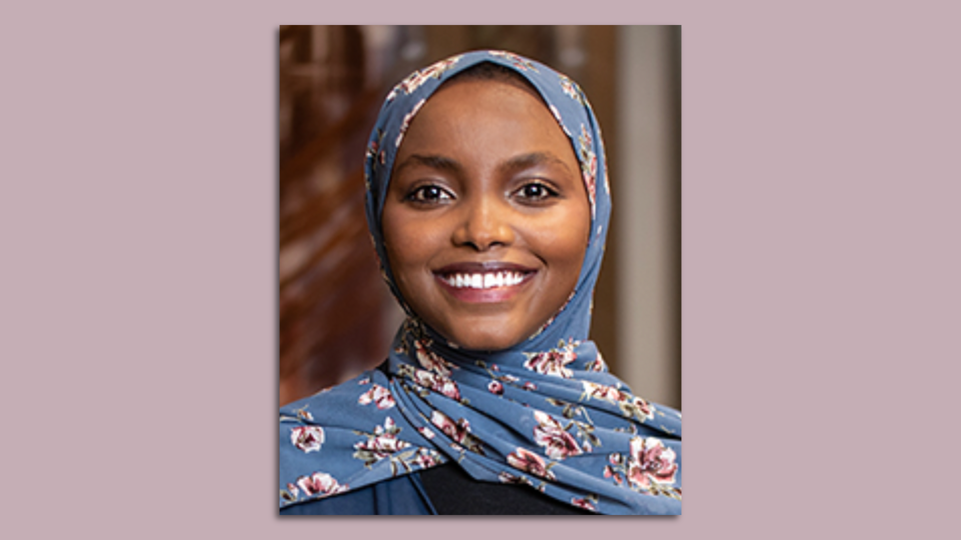 Woman with blue and flowererd hijab smiling