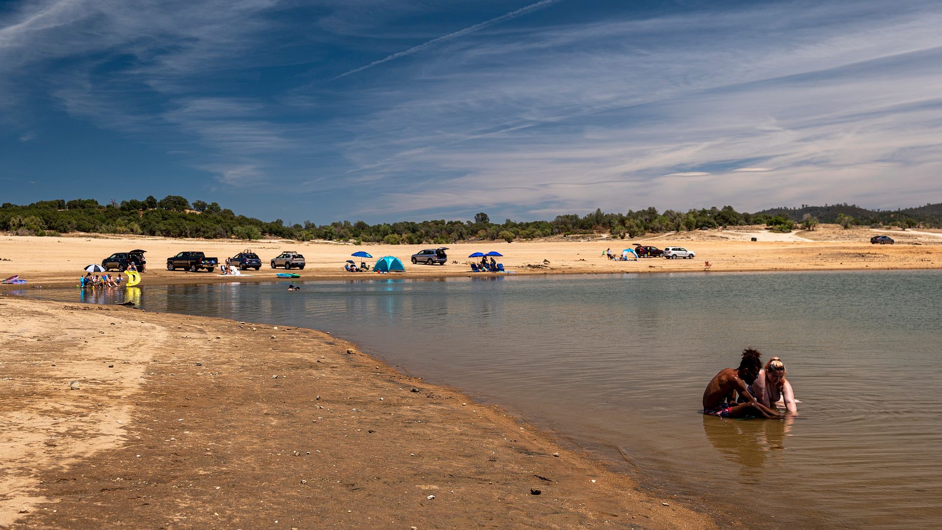A couple bathes in a dwindling lake starved of water by drought and heat in California.