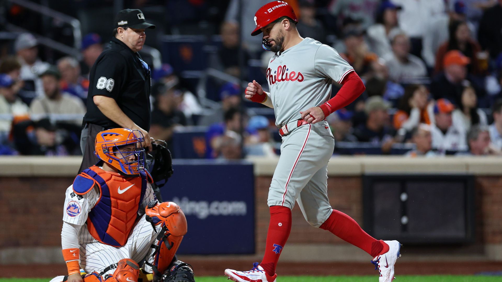 The Phillies Kyle Schwarber crosses home plate during his team's 7-2 loss to the Mets in Game 3 of the NLDS.