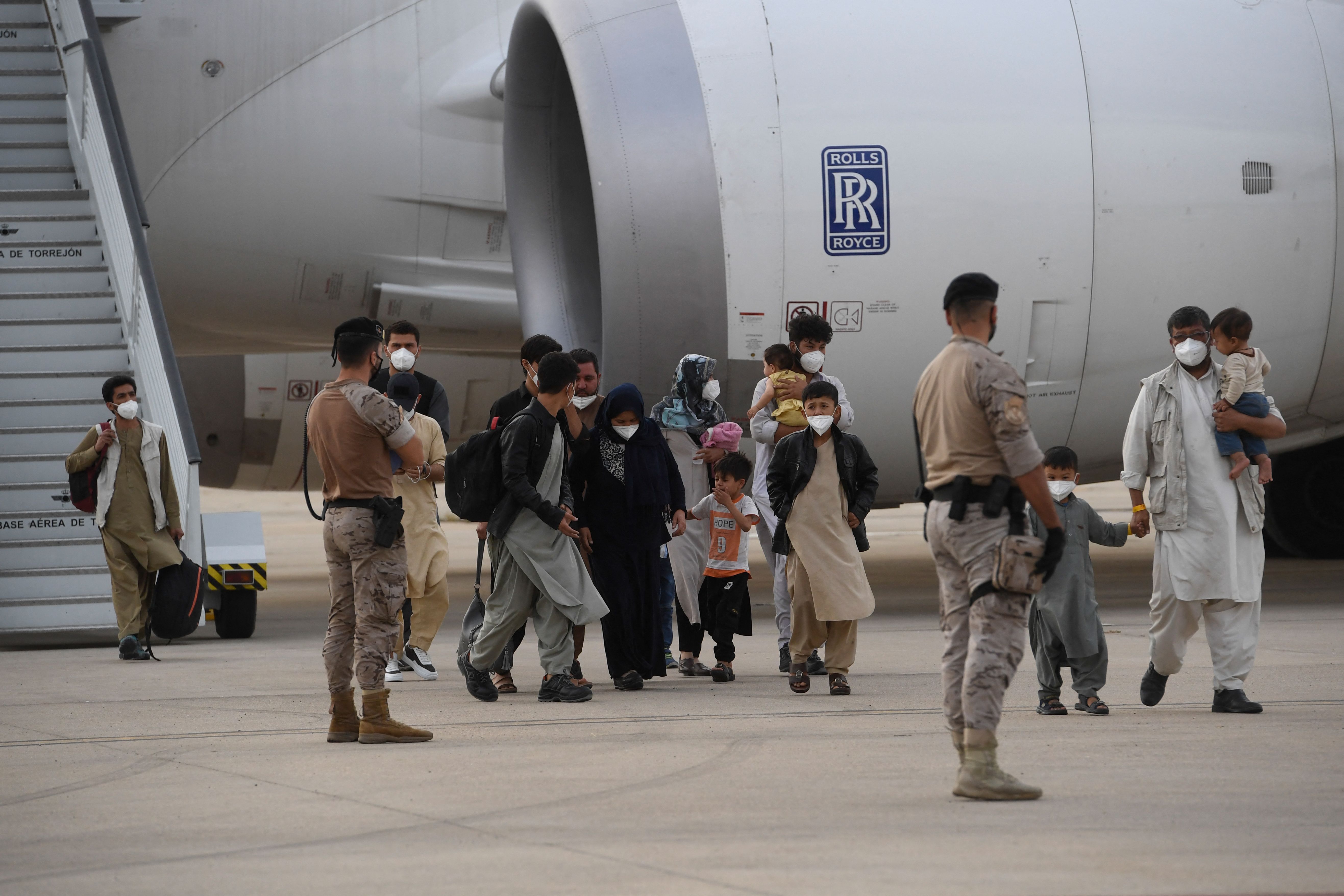 Refugees disembark from an evacuation flight after being airlifted from Kabul, at the Torrejon de Ardoz air base, 30 km from Madrid, on August 24