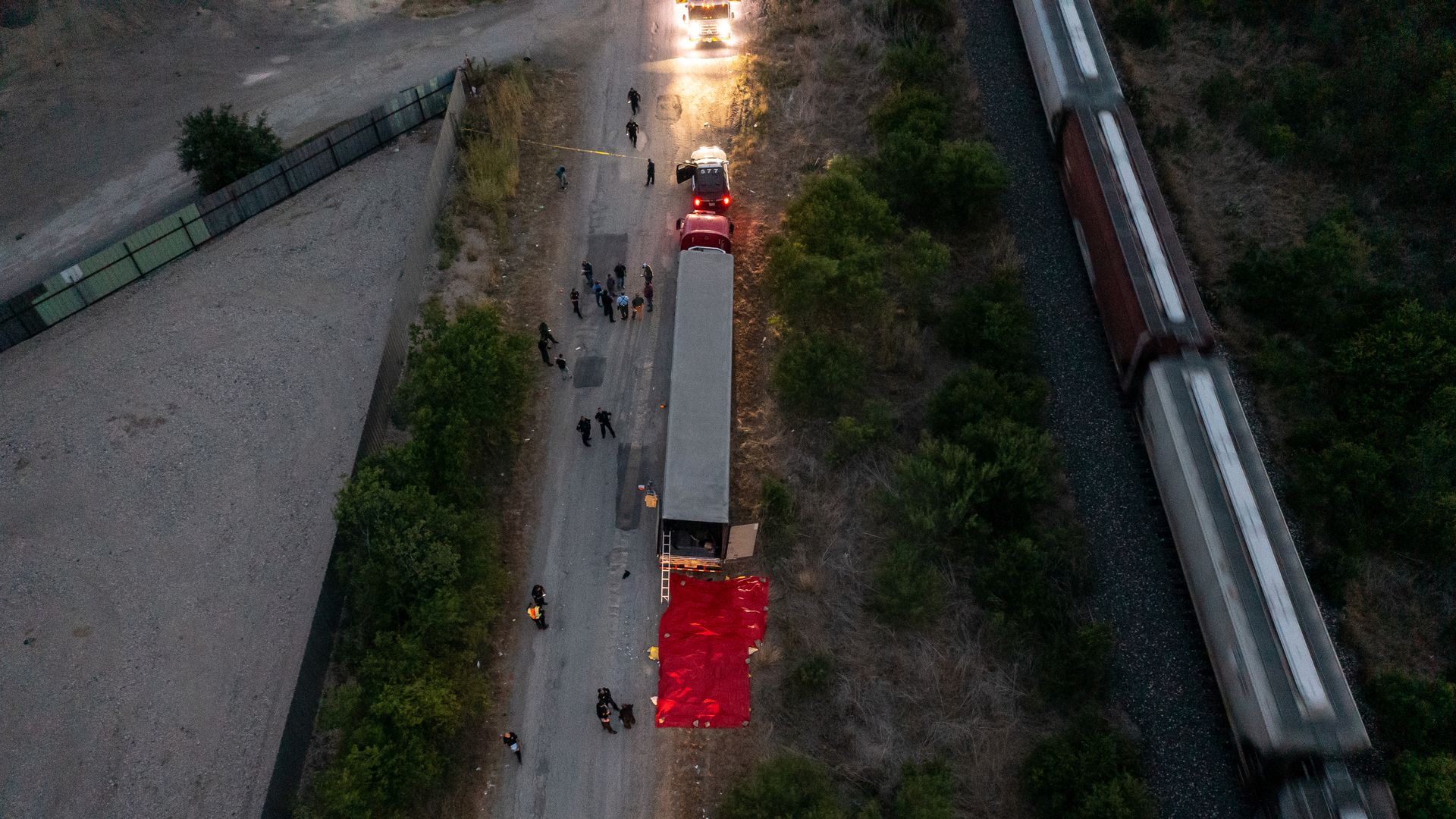  In this aerial view, members of law enforcement investigate a tractor trailer on June 27, 2022 in San Antonio, Texas. 