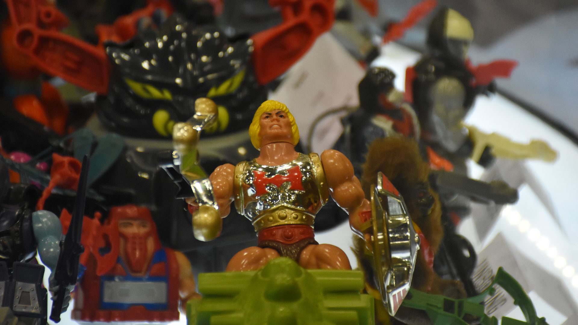 He-Man action figure toy under holiday tree