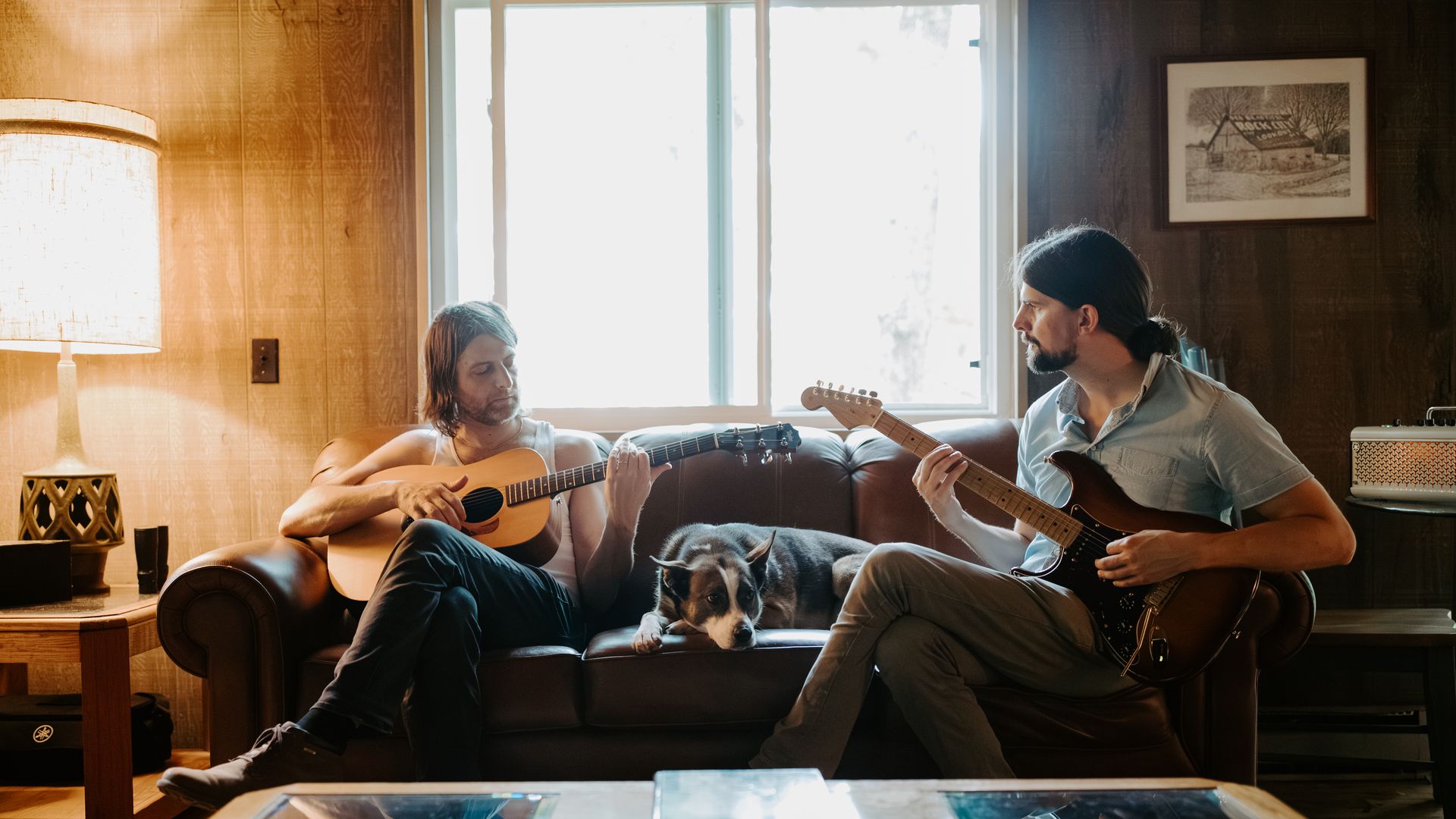 Two musicians sit on a couch