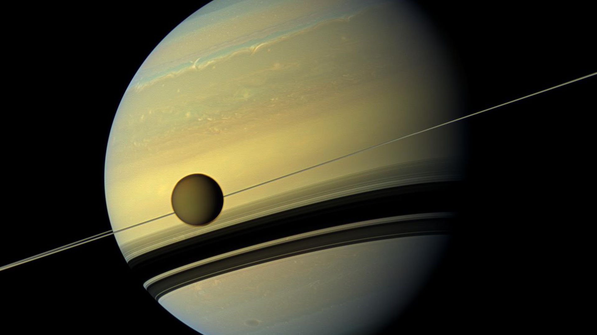 Titan in front of Saturn and its rings.