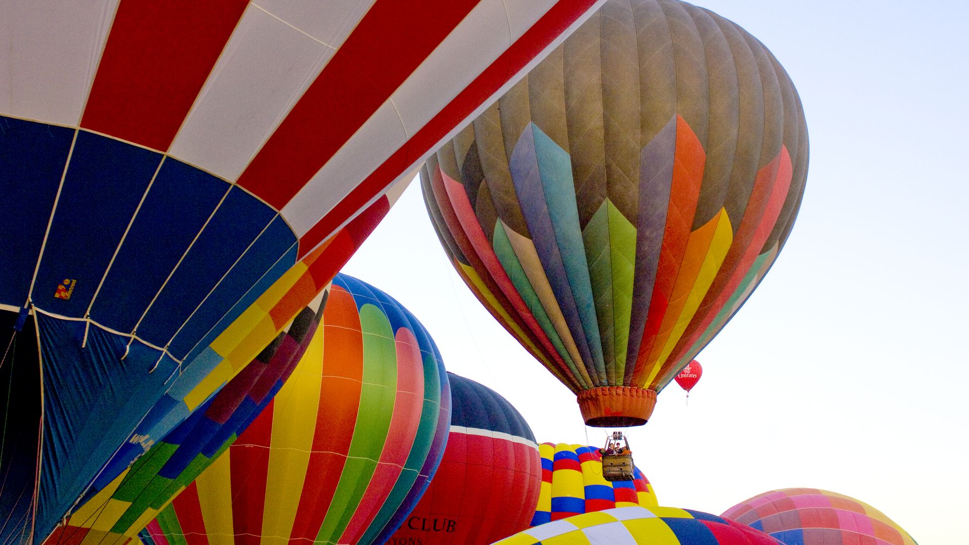 Many hot air balloons in the sky.