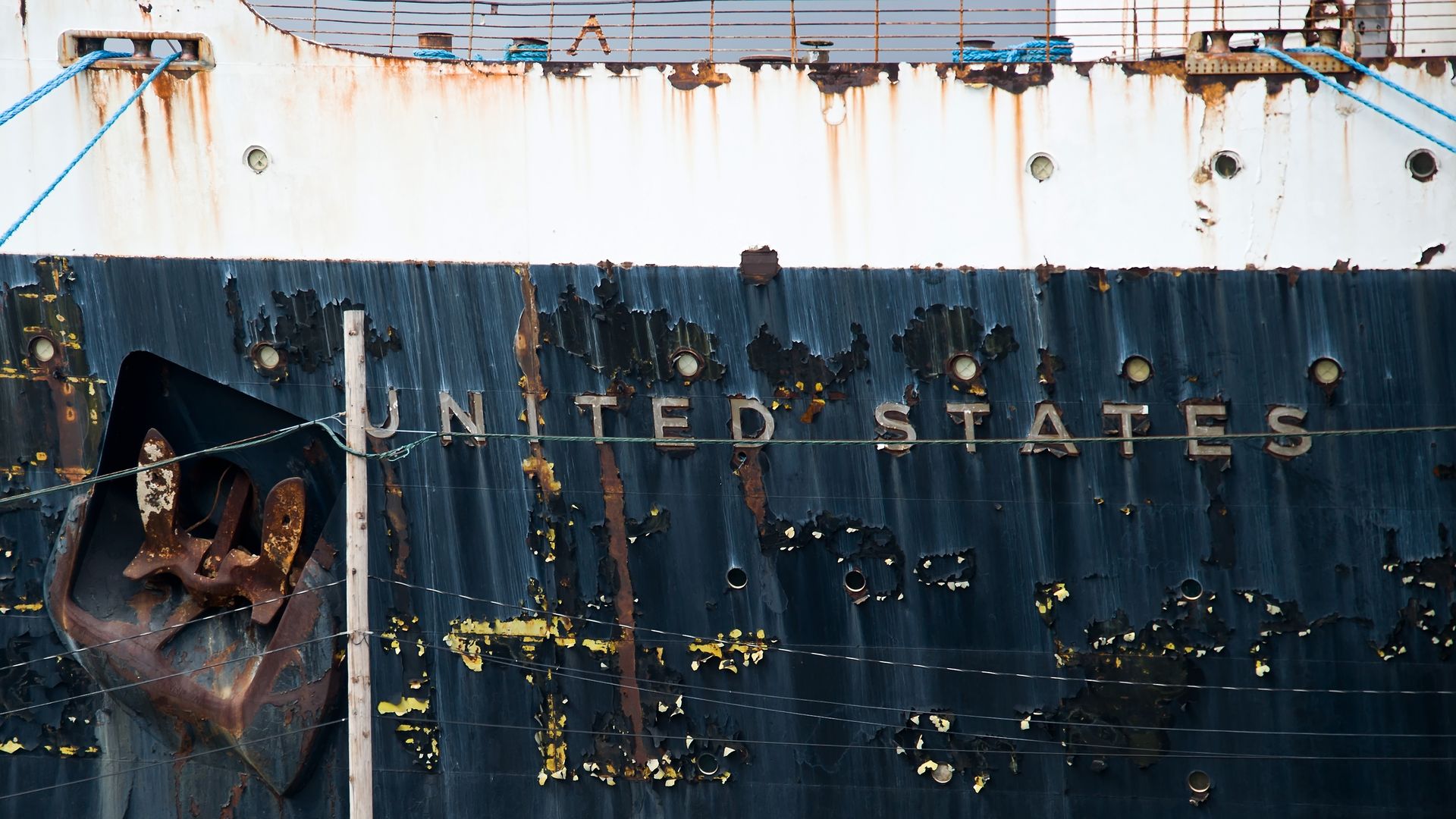 The paint-chipped exterior of the SS United States.