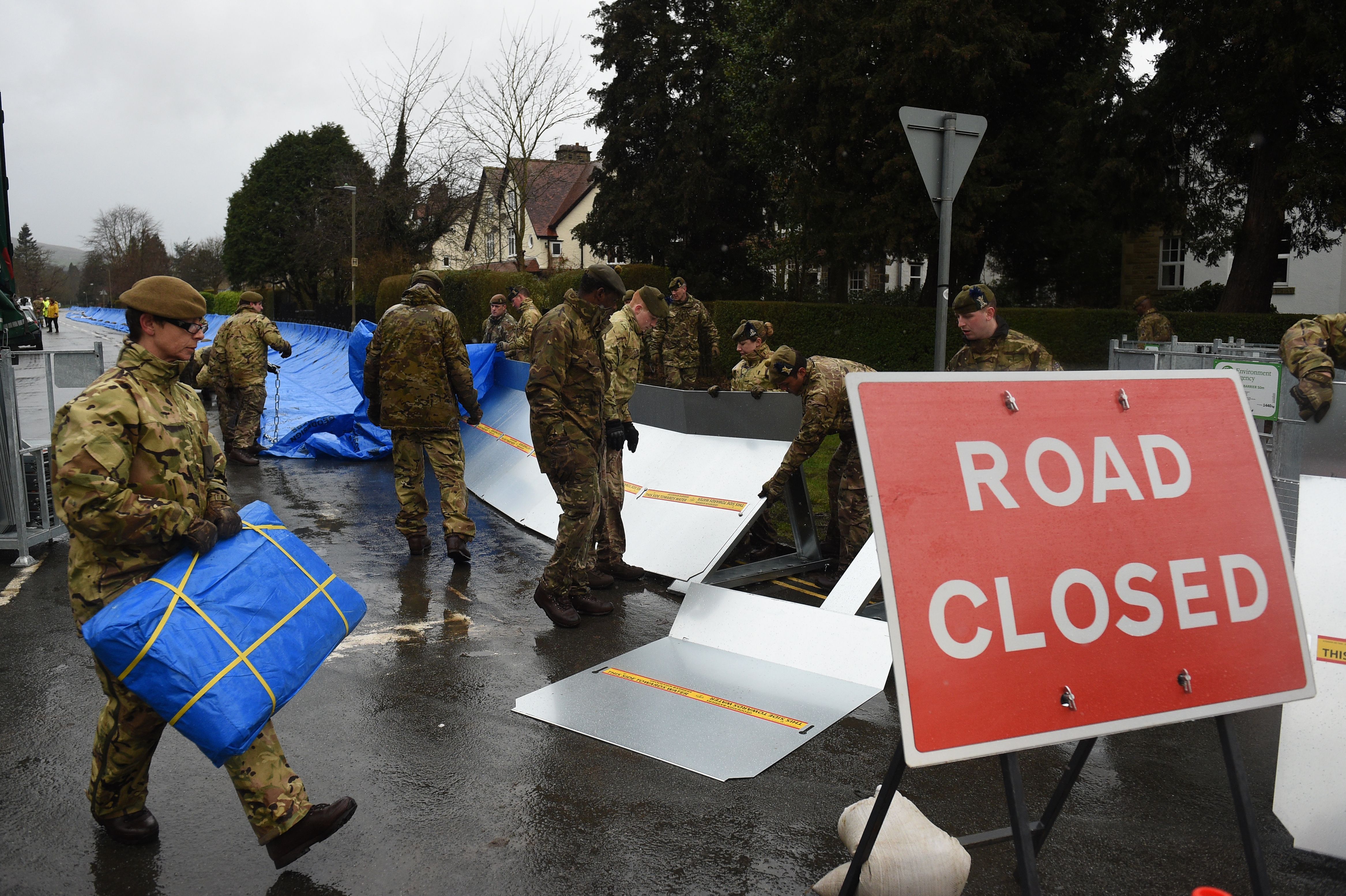 Members of the 4th Battalion Royal Regiment of Scotland erect flood barricades in Ilkley, West Yorkshire on February 15, 2020