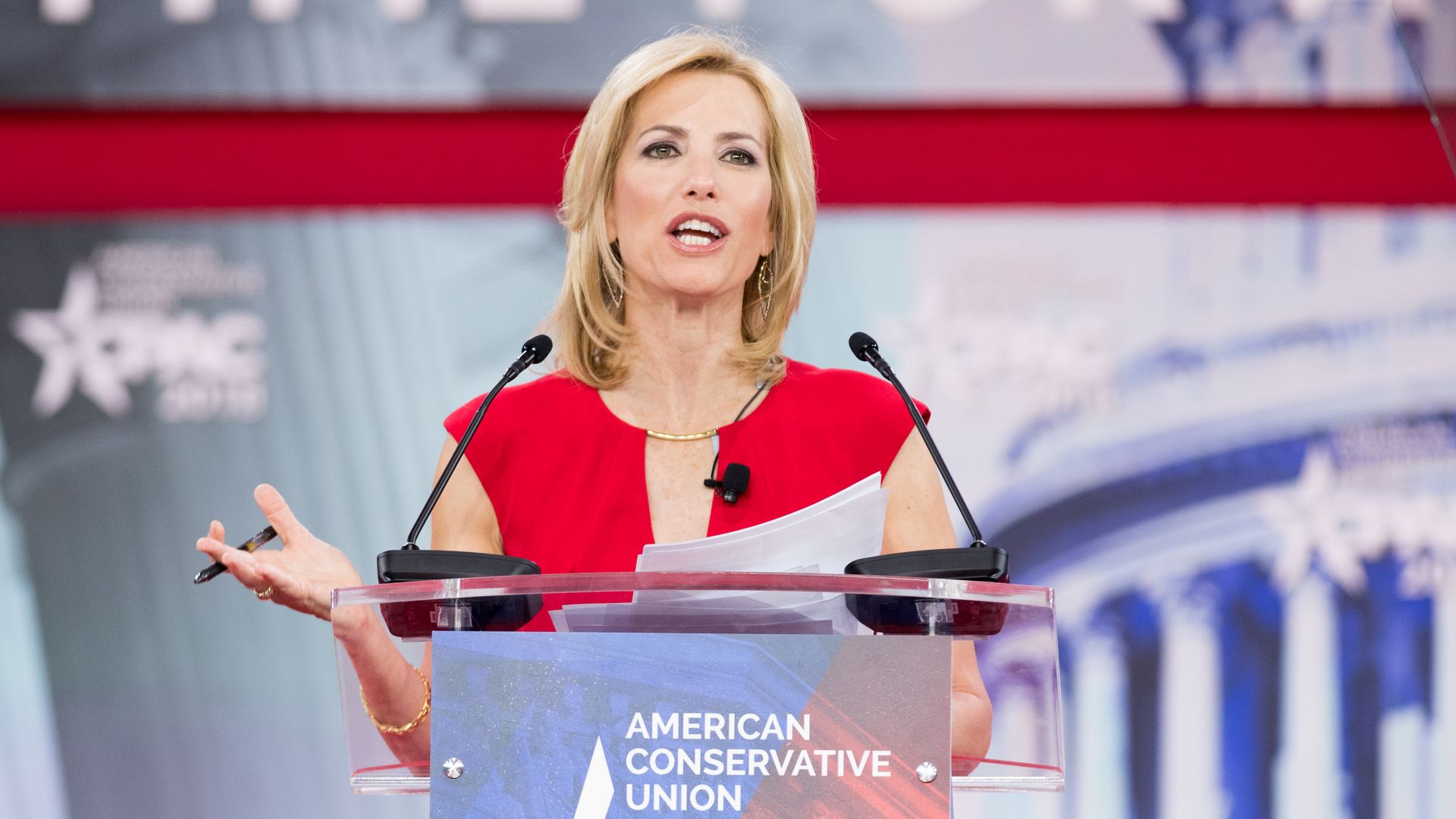 Laura Ingraham looks mad talking at a podium