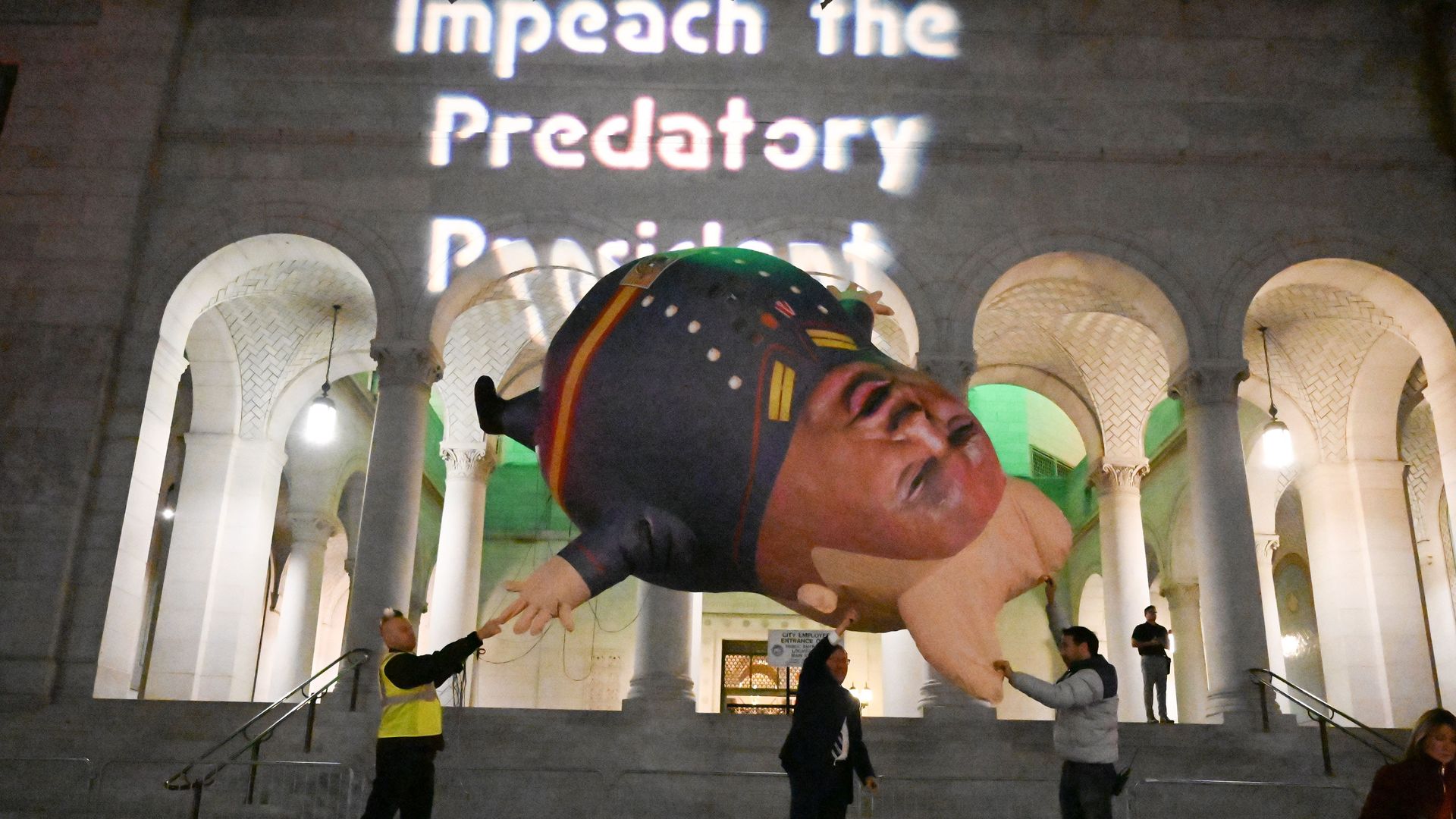 rotestors prepare to release a "Comrade Trump" balloon at a demonstration in support of his impeachment in downtown Los Angeles