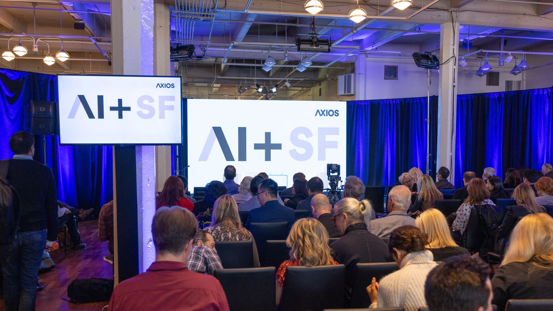 A conference room with signs that say AI+SF