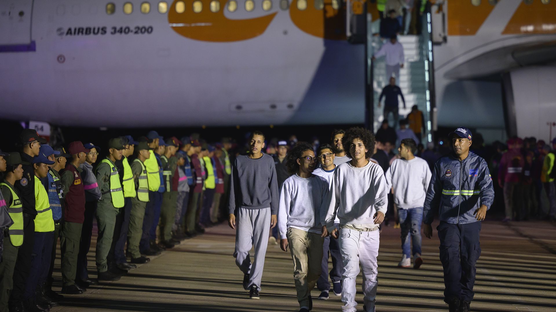 Deported individuals from the US arrive on a flight at Simon Bolivar International Airport in Maiquetia, Vargas state, Venezuela, early on Monday, March 24, 2025. 