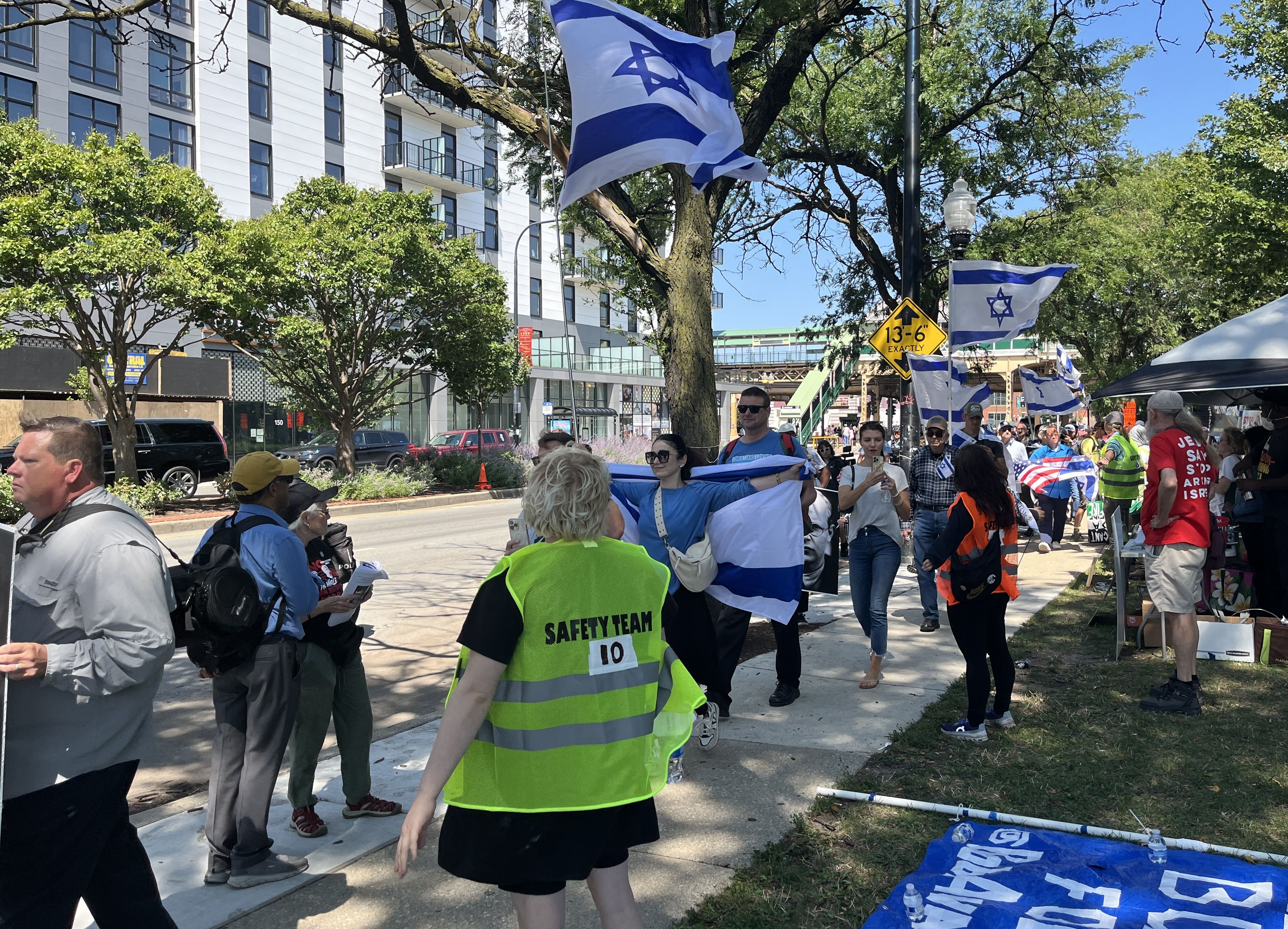 Marchers carry Israel flags.
