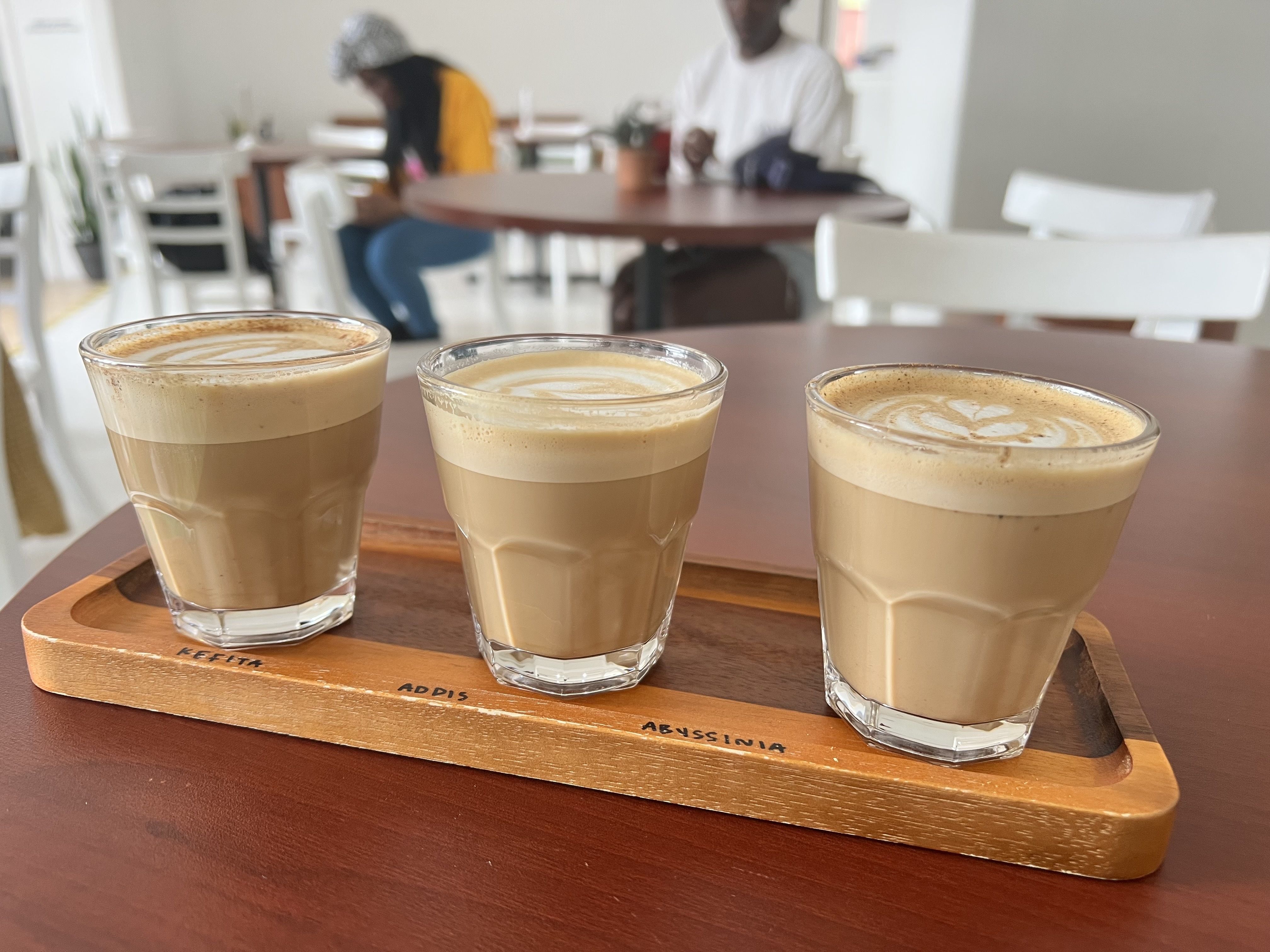 Photo of three small cups of latte. 