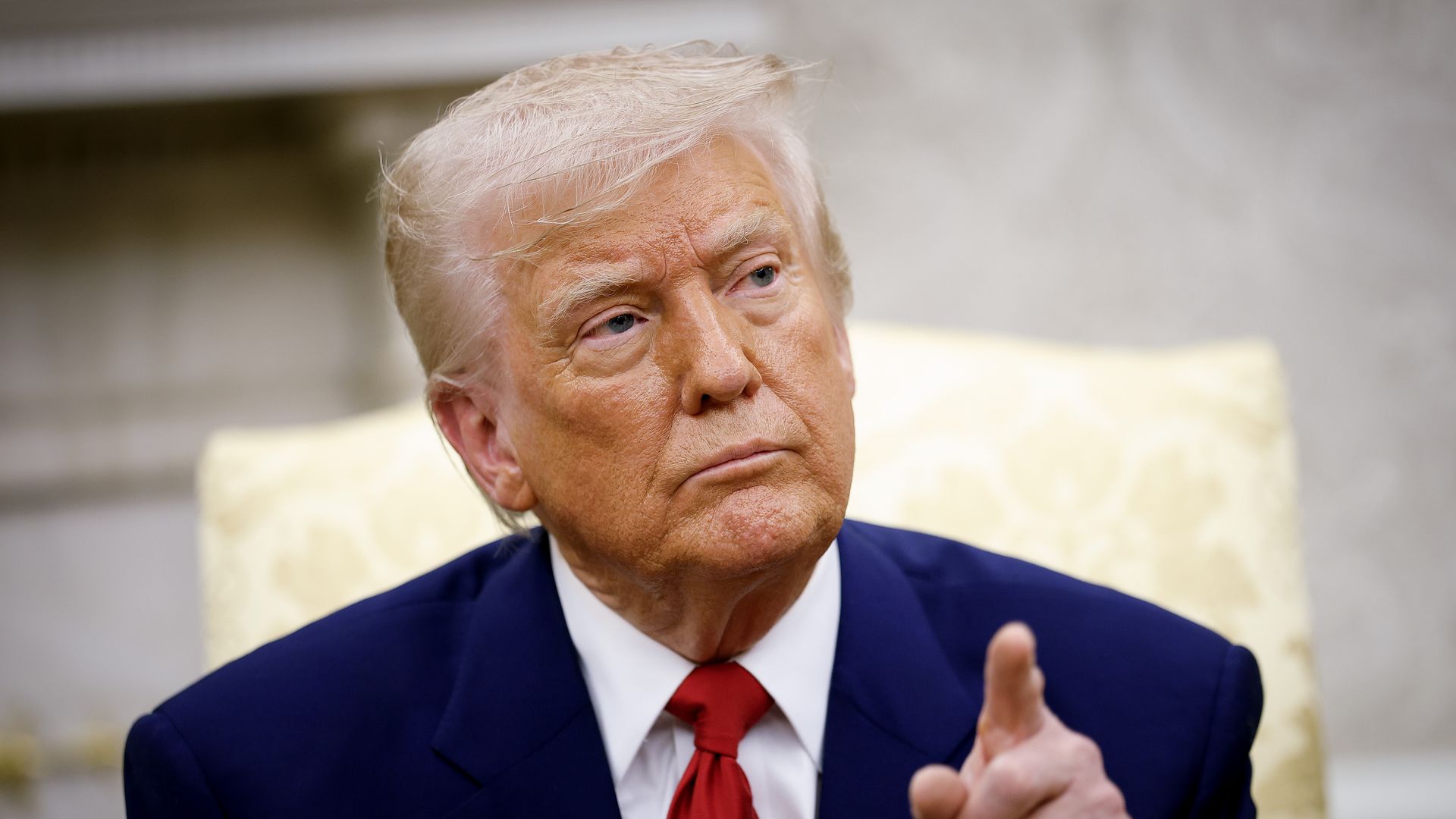 President Trump gestures in the Oval Office. 