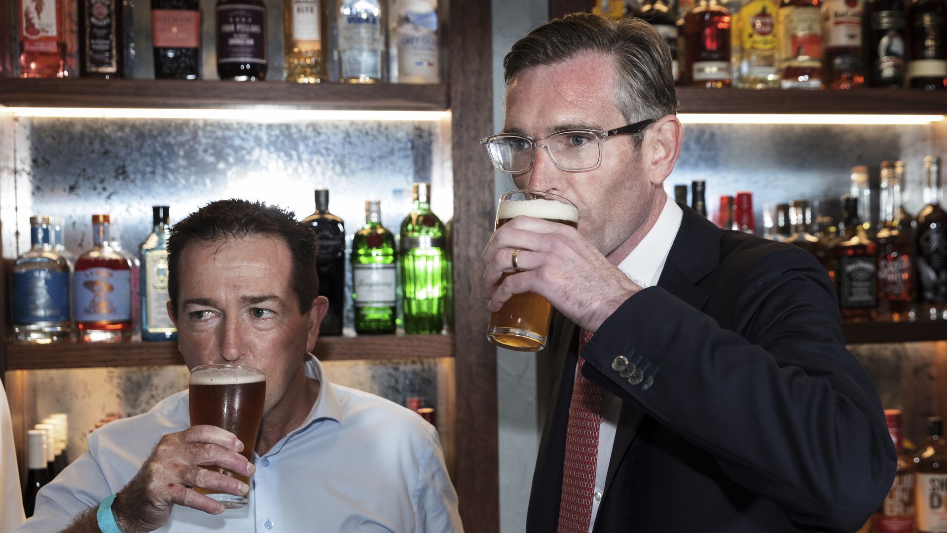  New South Wales Deputy Premier Paul Toole and Premier Dominic Perrottet drink a beer before holding a media conference at Watson’s Pub in Moore Park on October 11, 2021 in Sydney, Australia.