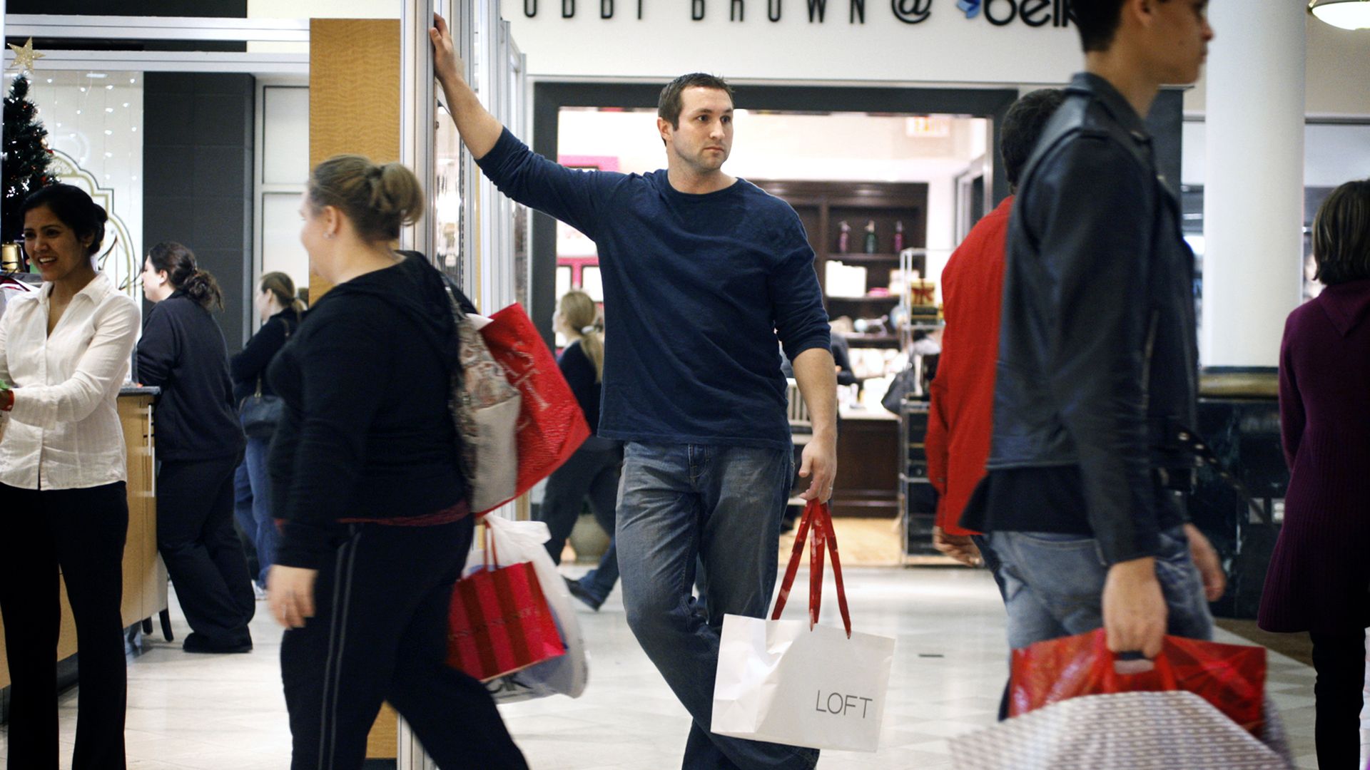 Dan Meyer holds his wife's shopping bag while she shops in another store at Crabtree Valley Mall in Raleigh, North Carolina, Friday, November 26, 2010. (Photo by Shawn Rocco/Raleigh News & Observer/Tribune News Service via Getty Images)