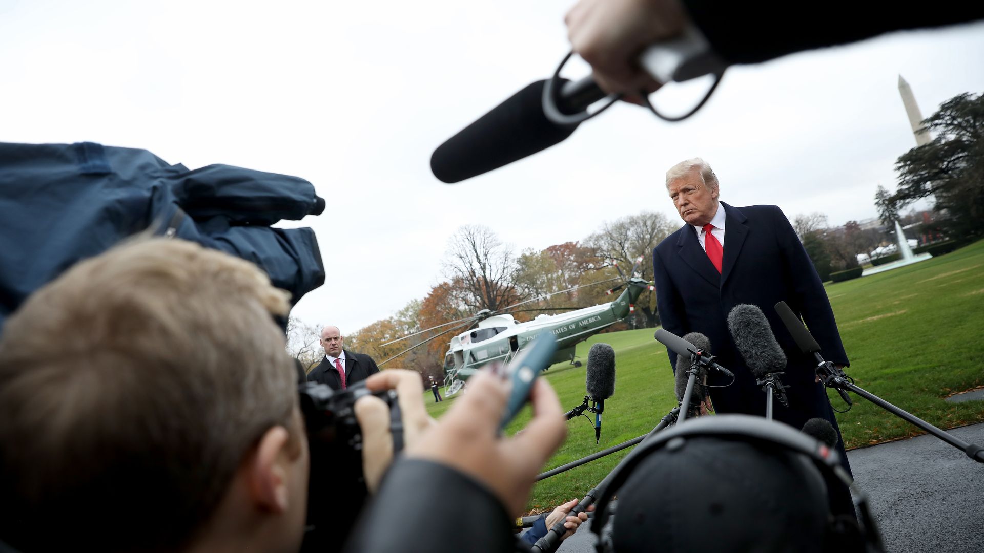 Donald Trump surrounded by media.