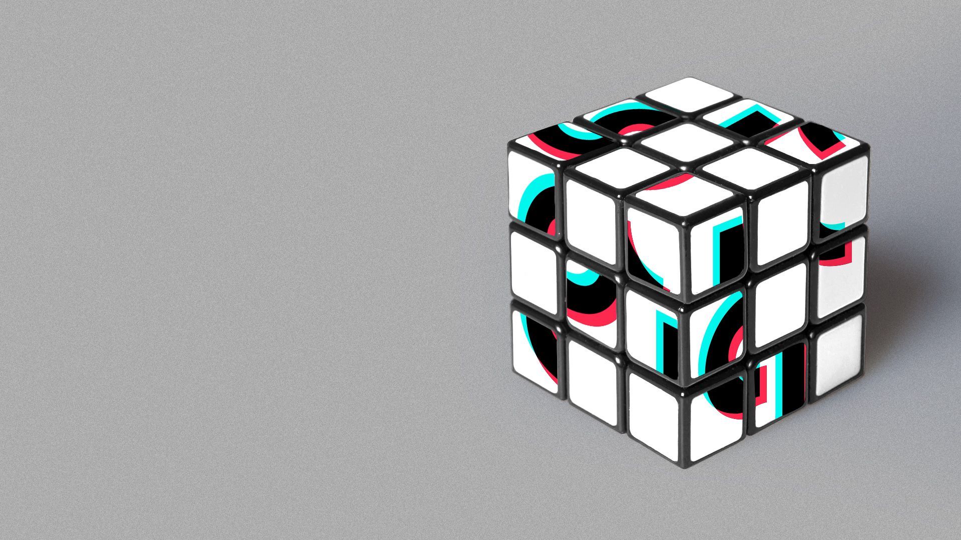 Illustration of a Rubik's cube with the Tik Tok logo mixed up. 