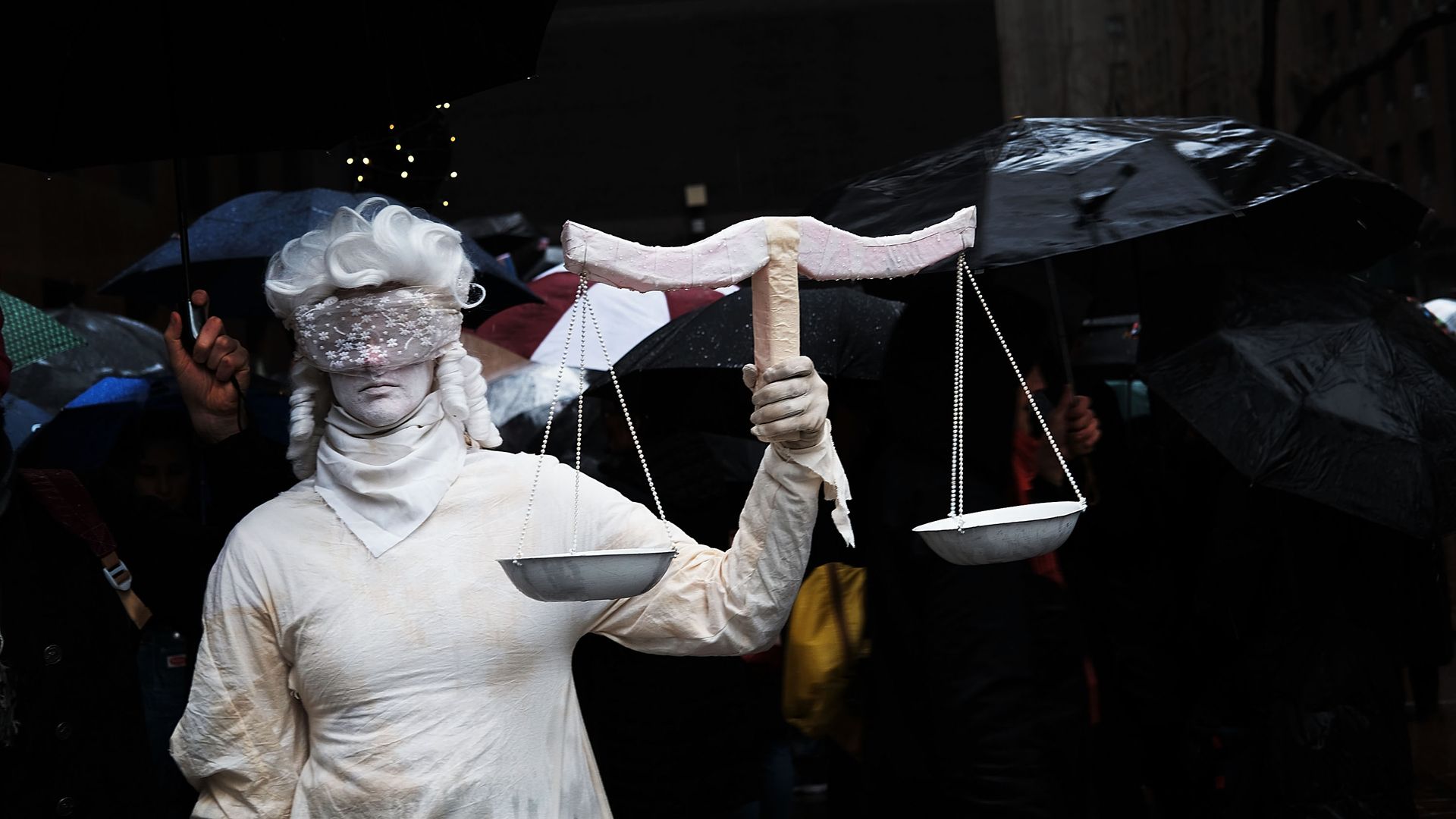 Woman dressed as lady justice blind folded